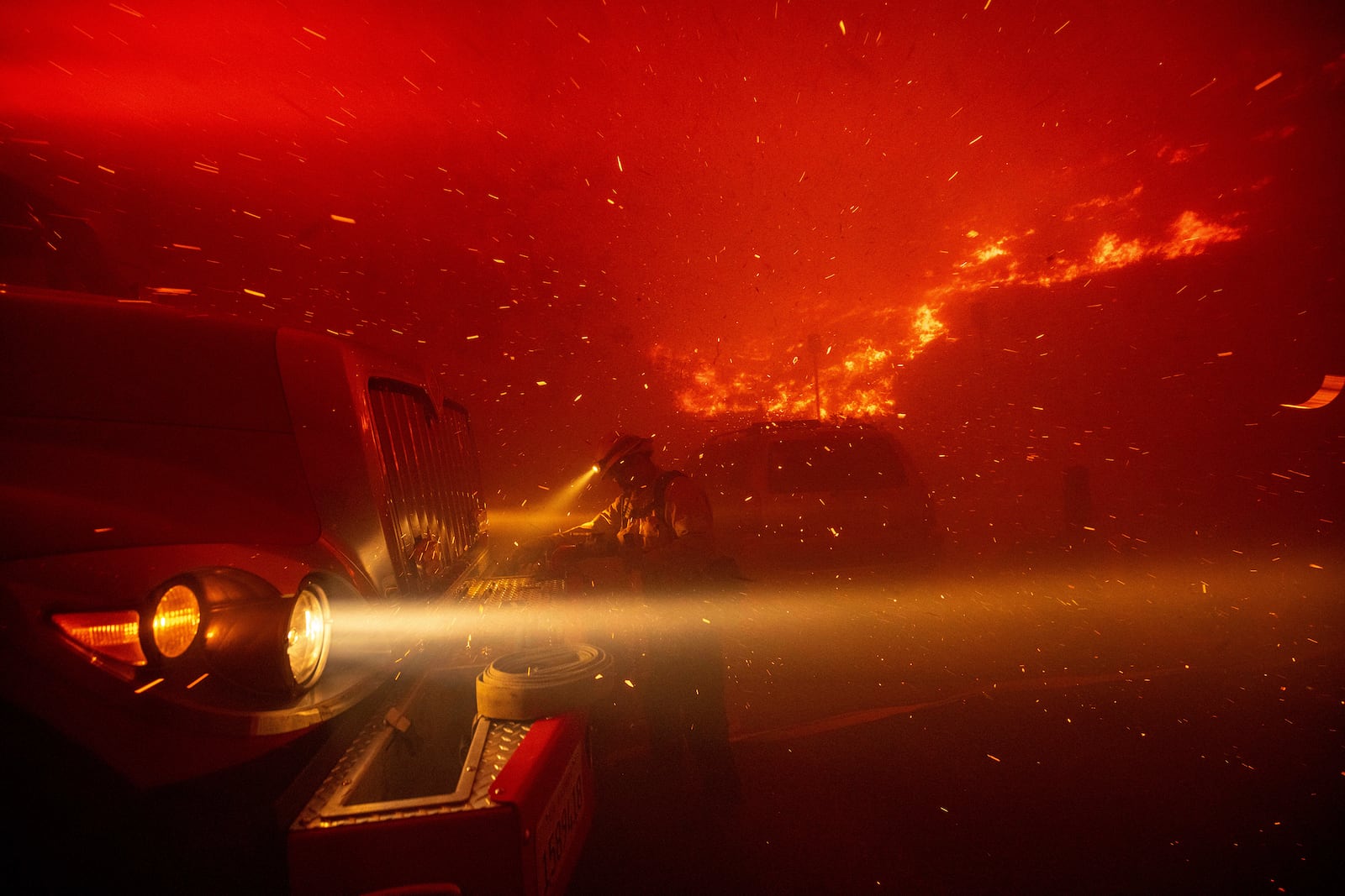 Firefighters battle the Franklin Fire in Malibu, Calif., on Tuesday, Dec. 10, 2024. (AP Photo/Ethan Swope)