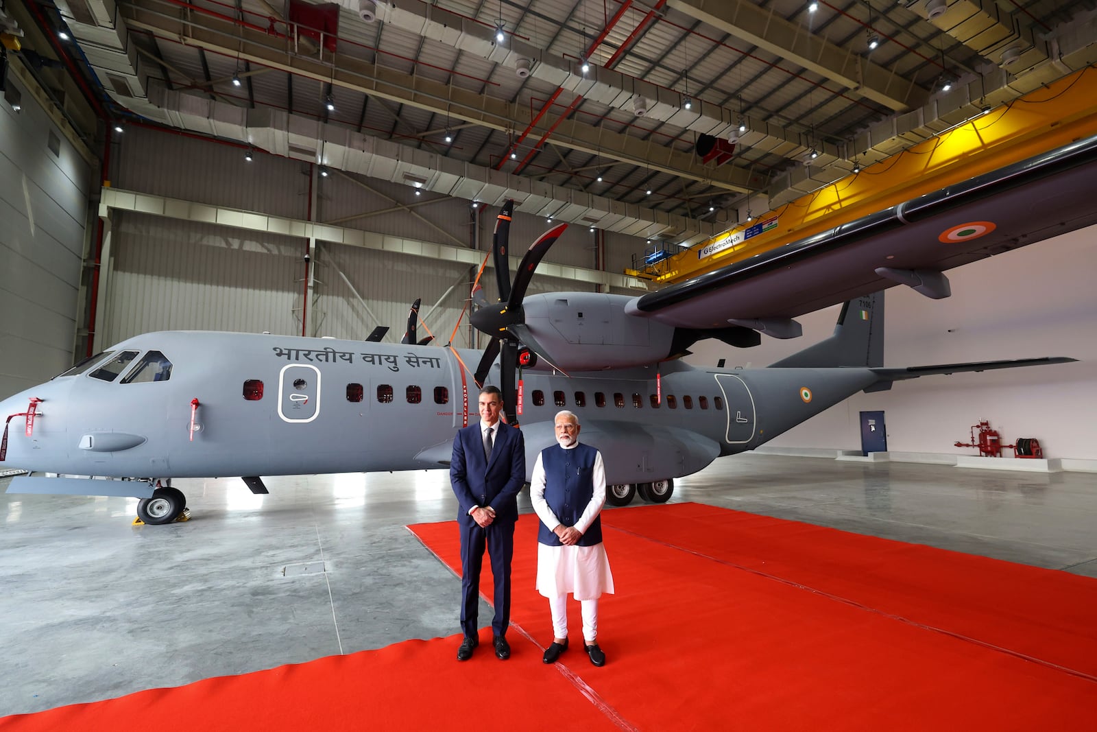 In this photo provided by the Gujarat state Press Information Bureau, Indian Prime Minister Narendra Modi and his Spanish counterpart Pedro Sanchez, pose in front of C-295 transport military aircraft after inaugurating India's first private military aircraft plant in Vadodara, India, Monday, Oct. 28, 2024. (Gujarat State Press Information Bureau via AP)