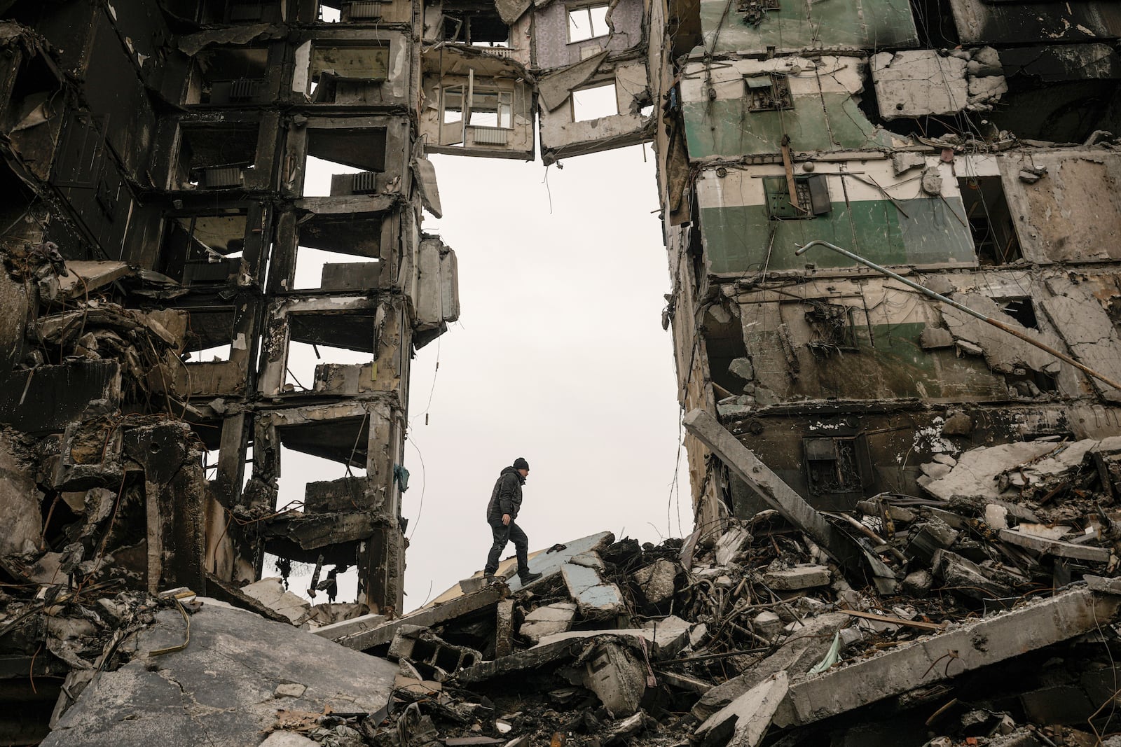 FILE - A resident looks for belongings in an apartment building destroyed during fighting between Ukrainian and Russian forces in Borodyanka, Ukraine, Tuesday, April 5, 2022. (AP Photo/Vadim Ghirda, File)