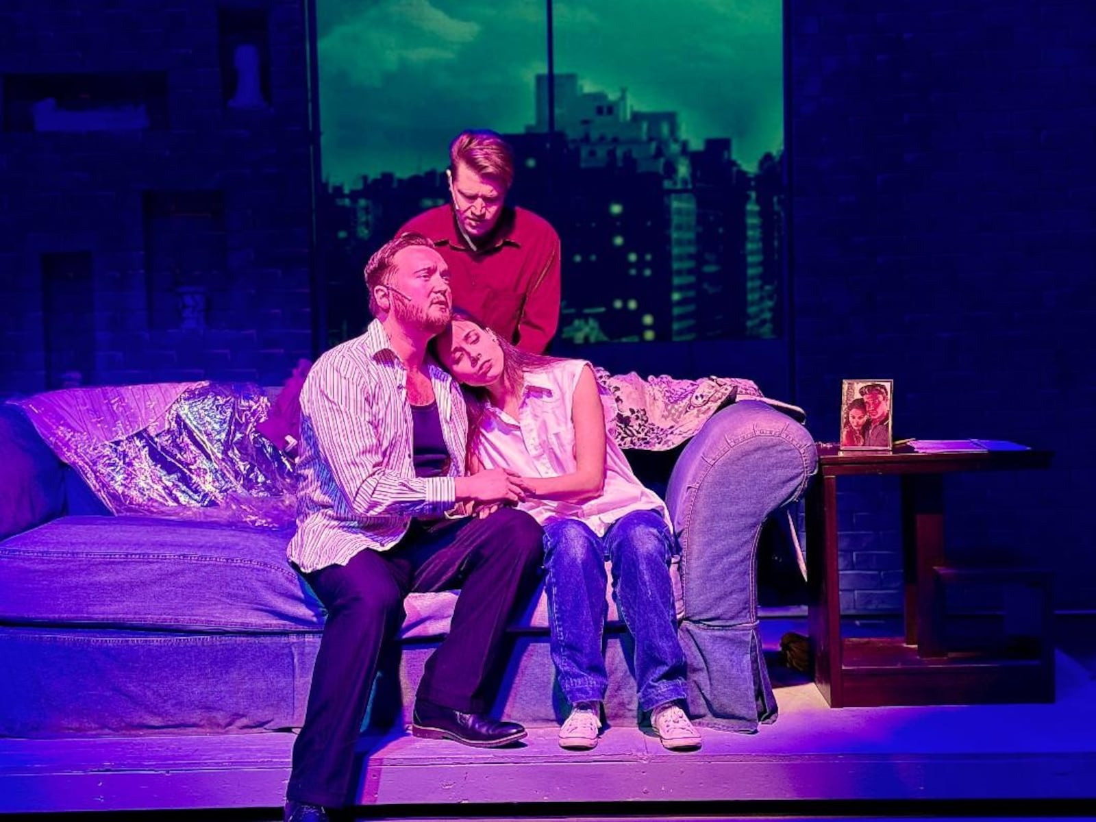 Montana Iverson (Sam Wheat, standing), Dylan Jackson (Carl Bruner) and Charmien Byrd (Molly Jensen) in La Comedia Dinner Theatre's production of "Ghost: The Musical." PHOTO BY JUSTIN WALTON