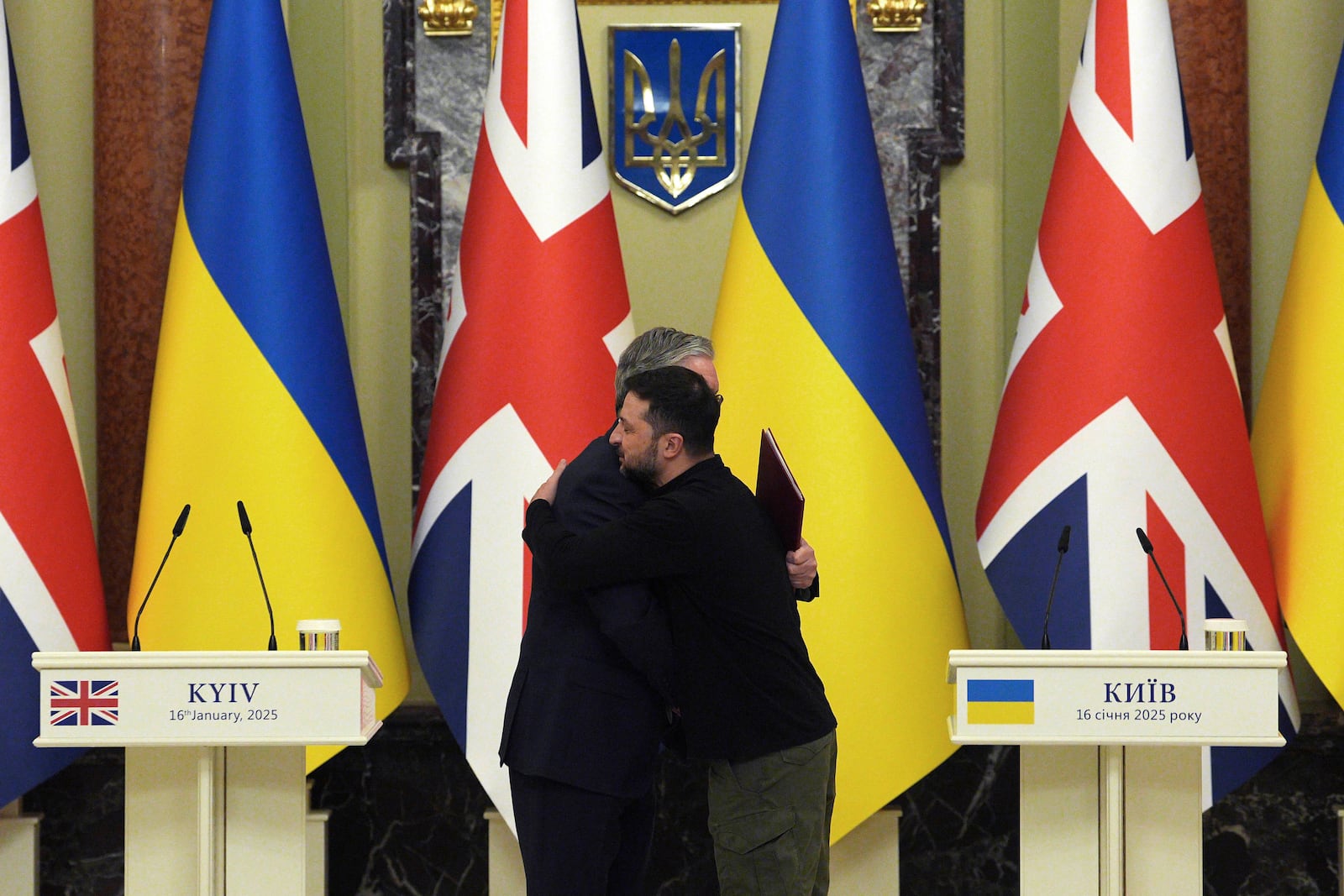 British Prime Minister Keir Starmer, left and Ukrainian President Volodymyr Zelenskyy hug, at the start of their bilateral talks at Mariinskyi Palace, in Kyiv, Ukraine Thursday, Jan. 16, 2025. (Carl Court/Pool Photo via AP)