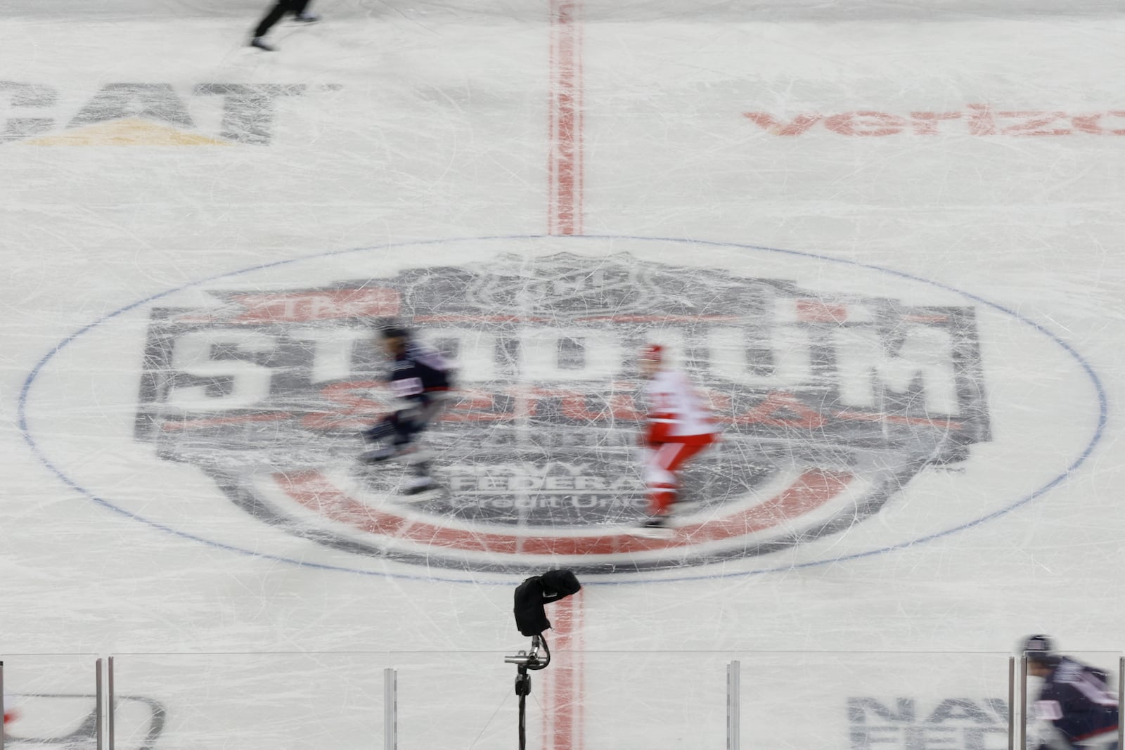 Players skate across during the first period of the Stadium Series NHL hockey game between the Detroit Red Wings and the Columbus Blue Jackets at Ohio Stadium, Saturday, March 1, 2025, in Columbus, Ohio. (AP Photo/Jay LaPrete)