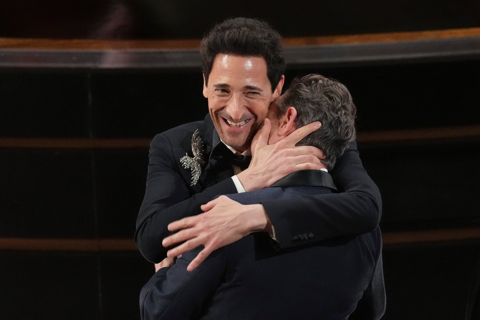 Adrien Brody, left, hugs Lol Crawley for winning the award for best cinematography for "The Brutalist" during the Oscars on Sunday, March 2, 2025, at the Dolby Theatre in Los Angeles. (AP Photo/Chris Pizzello)