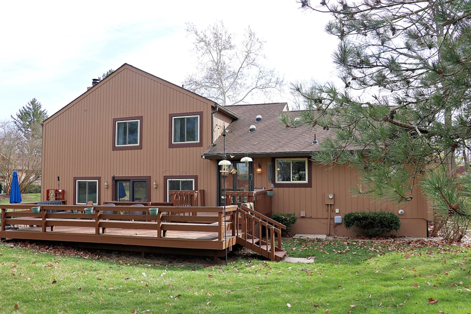 A paved driveway leads to the side-entry, two-car garage and ends near the backyard.