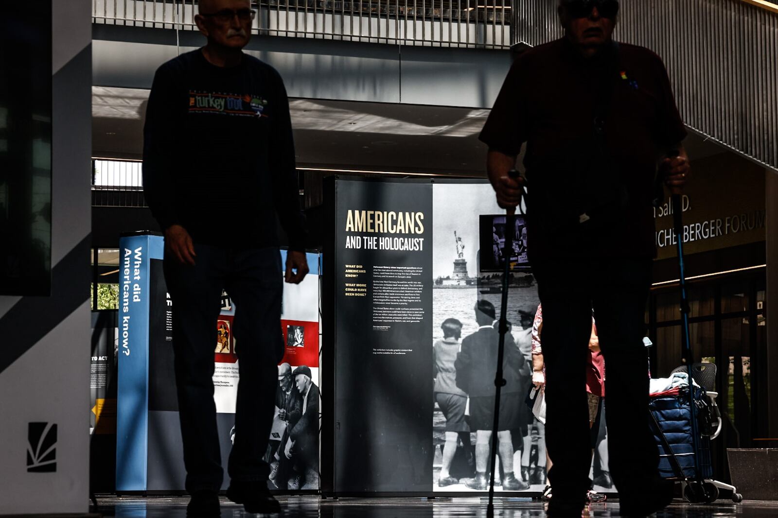 Dayton Metro Library visitors walk by an Americans and the Holocaust exhibition Wednesday June 21, 2023. The exhibition was brought to Dayton by the Library Association and the Holocaust Museum in Washington D.C. JIM NOELKER/STAFF