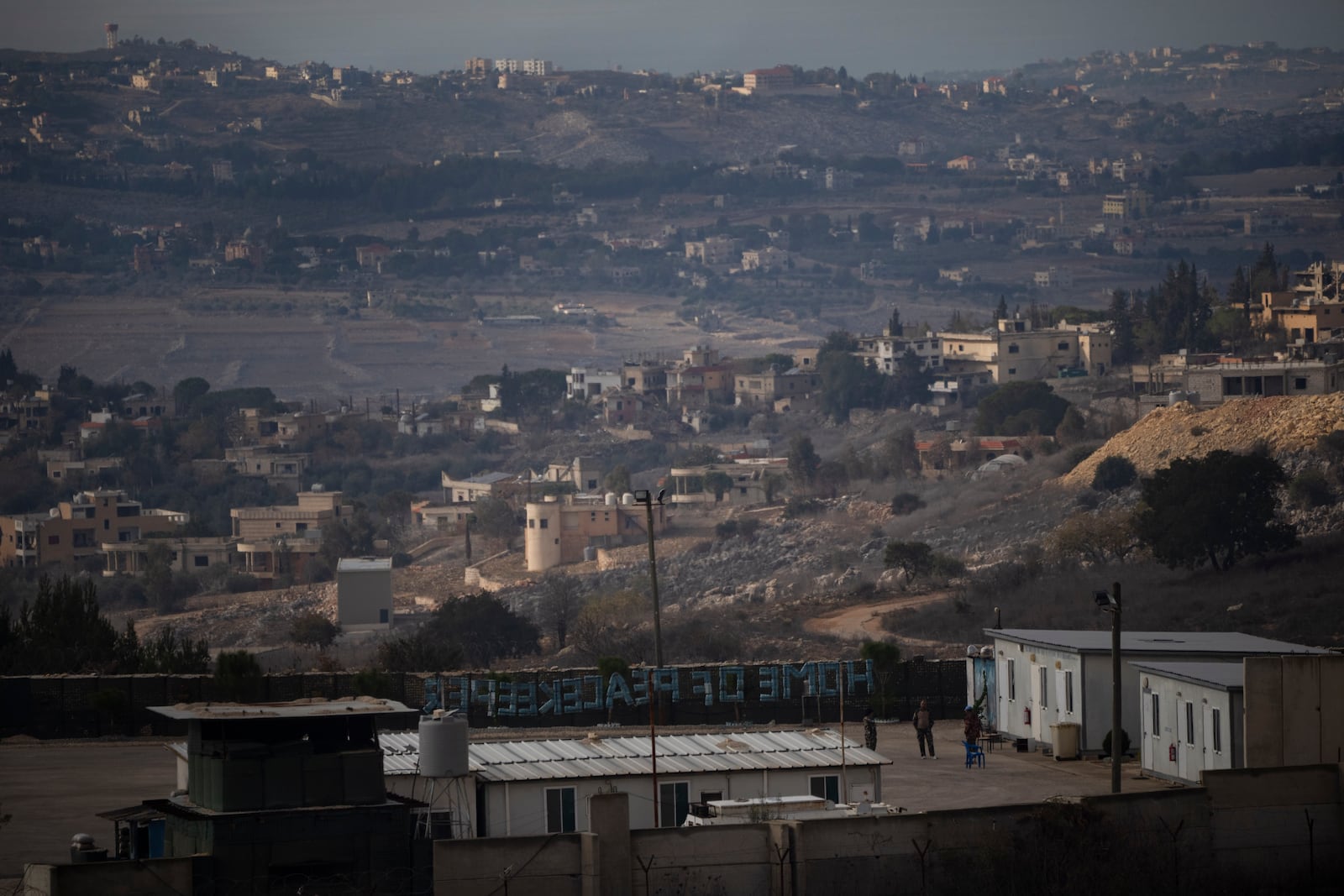 UN soldiers stand at a base of the United Nations peacekeeping forces in Lebanon (UNIFIL) at the Israeli-Lebanese border, as seen from the Kibbutz Manara, northern Israel, Thursday, Nov. 28, 2024. (AP Photo/Leo Correa)