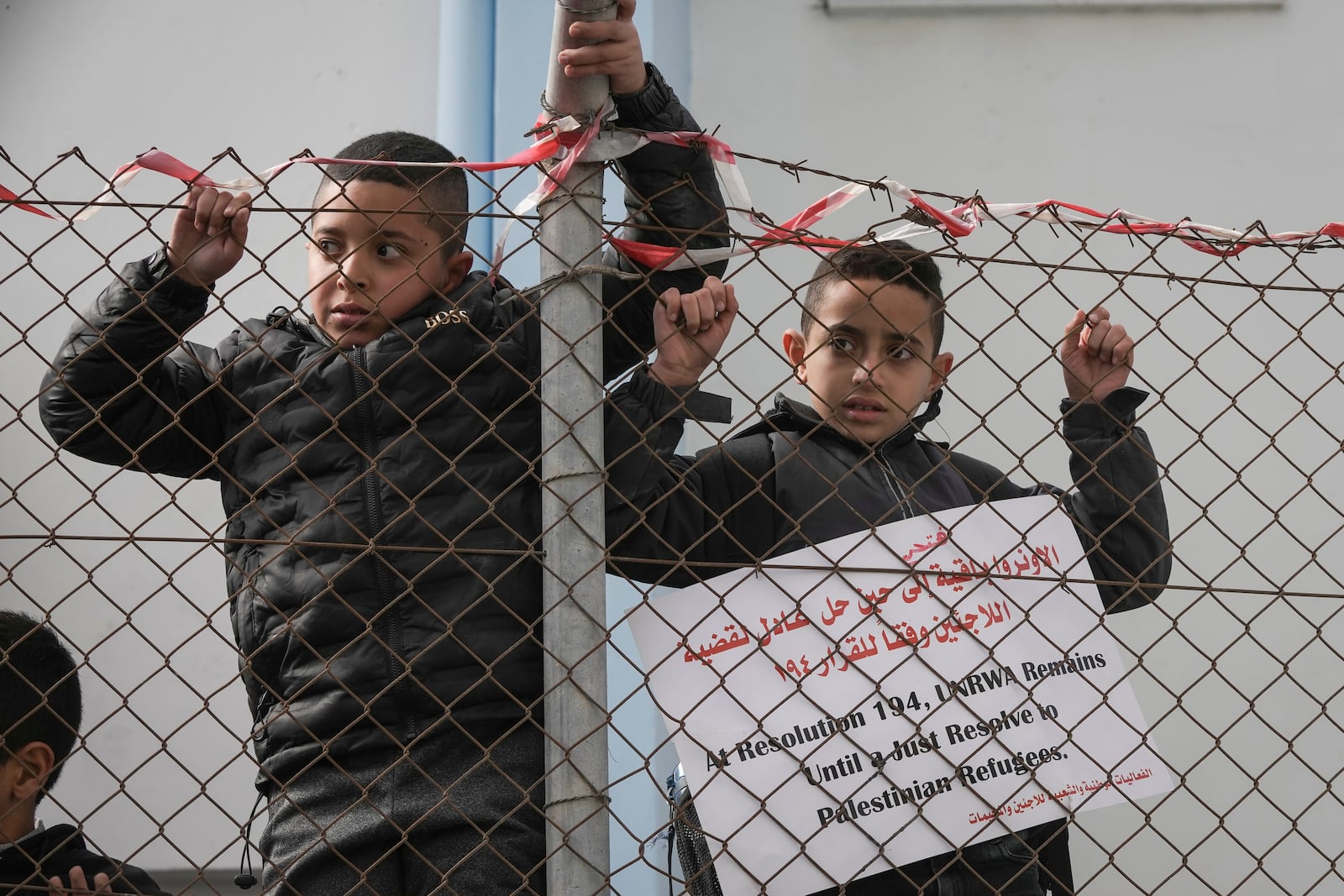 Palestinian youth demonstrate in front a UNRWA (UN agency for Palestinian refugees) clinic at the Qalandia refugee camp, to protest the Israel parliament decision preventing the agency to continue its work, in Qalandia Monday Nov. 2024. The laws ban the agency, UNRWA, from operating and cut all ties between the agency and the Israeli government.(AP Photo/Mahmoud Illean)