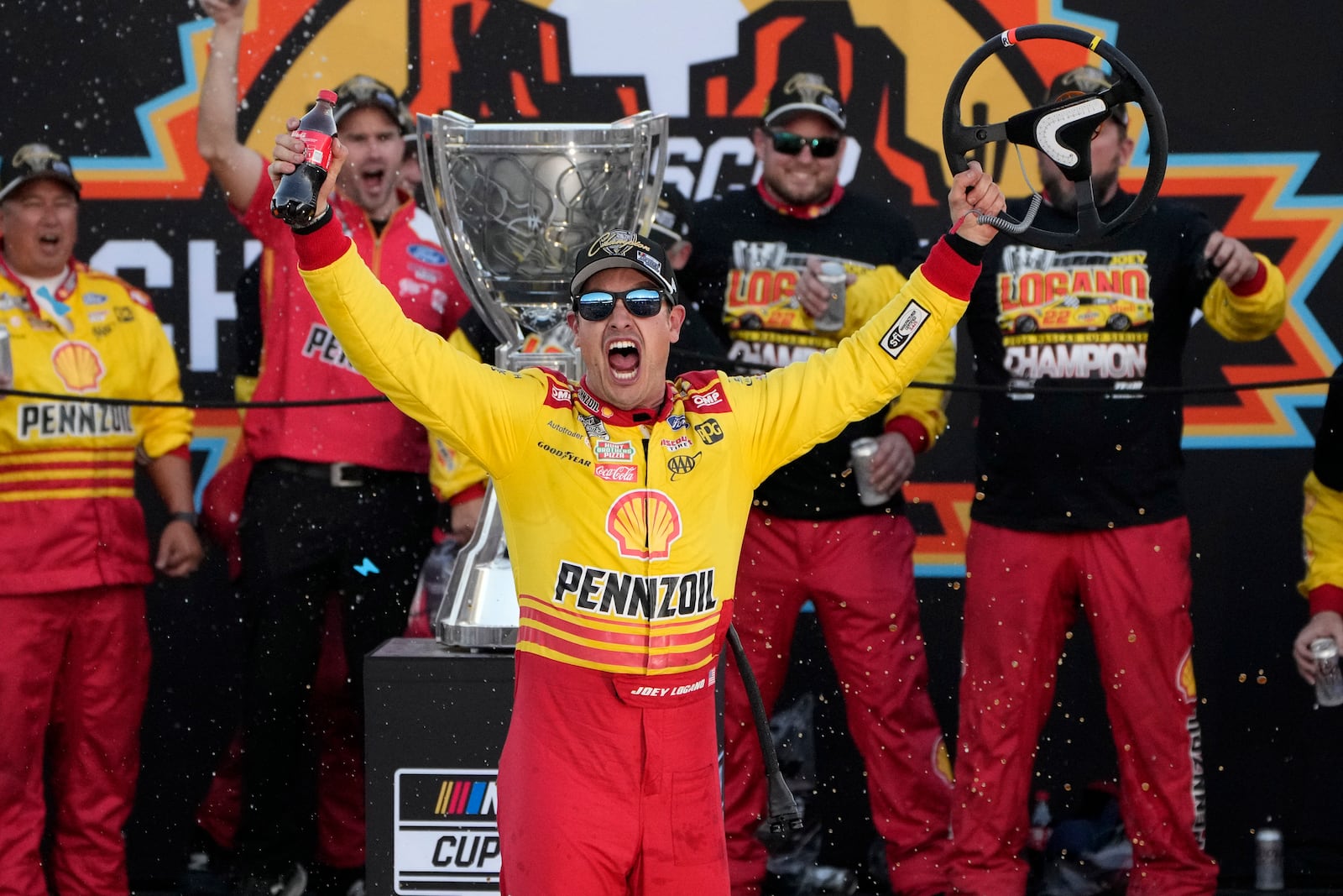 Joey Logano celebrates after winning a NASCAR Cup Series Championship auto race for the championship at Phoenix Raceway, Sunday, Nov. 10, 2024, in Avondale, Ariz. (AP Photo/John Locher)