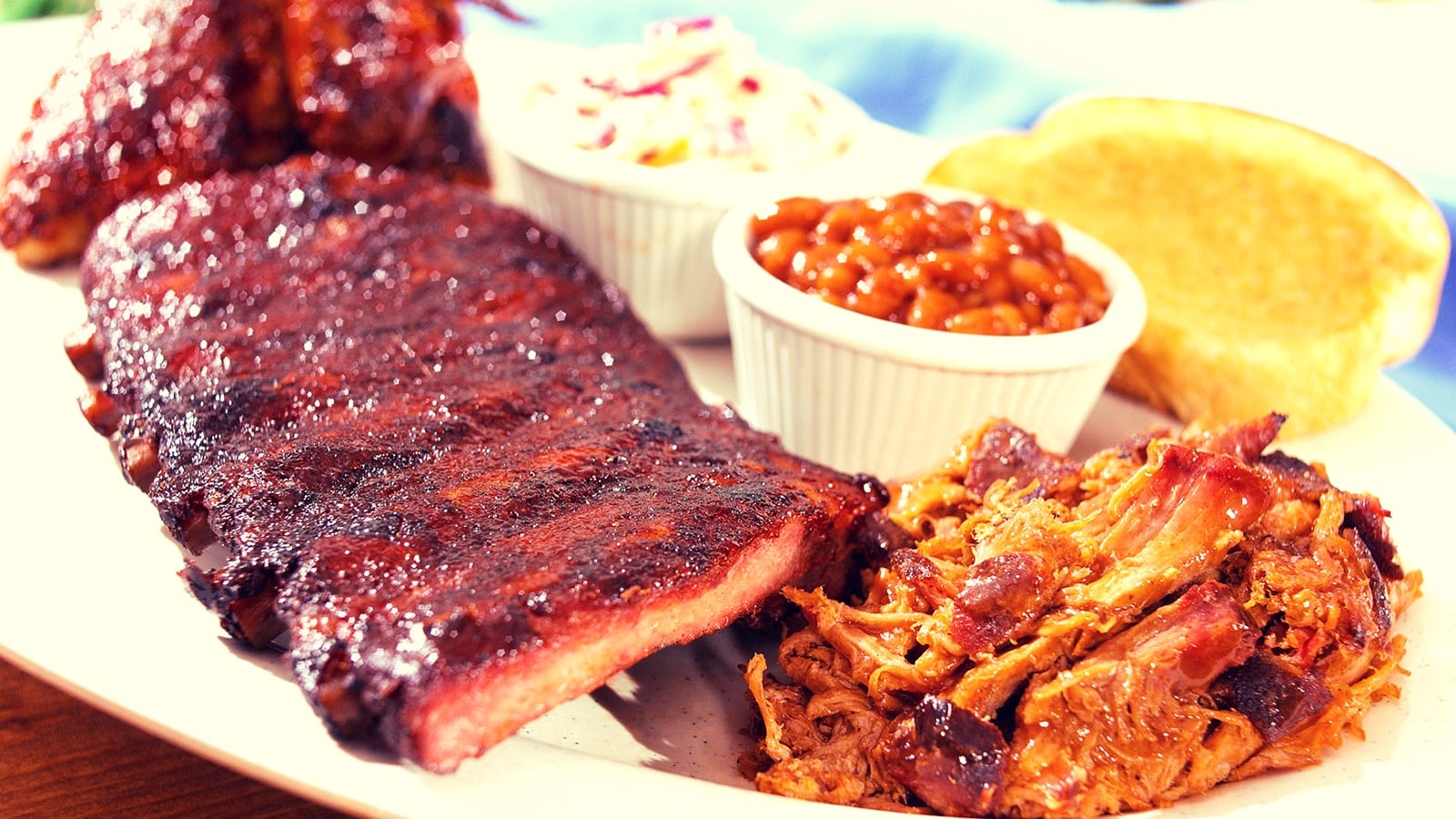 Baby back ribs, barbeque chicken and pulled pork combination platter is served at Smokey Bones. (Cox Newspapers)