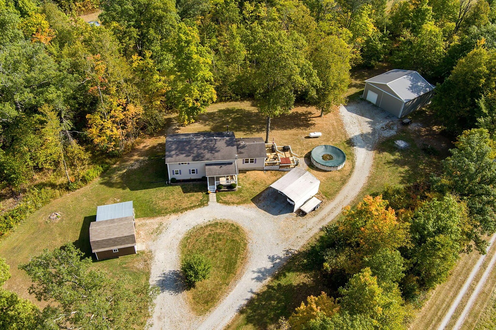 The property includes the pole barn, a car port and an additional barn as well as an above ground pool and hot tub.