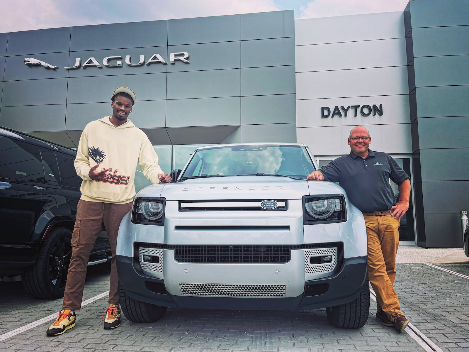 DaRon Holmes II poses for a photo with Tim White Jr, President of The White Family Companies, outside the White-Allen European Auto Group on North Springboro Pike on Tuesday, July 18, 2023, in Dayton. David Jablonski/Staff