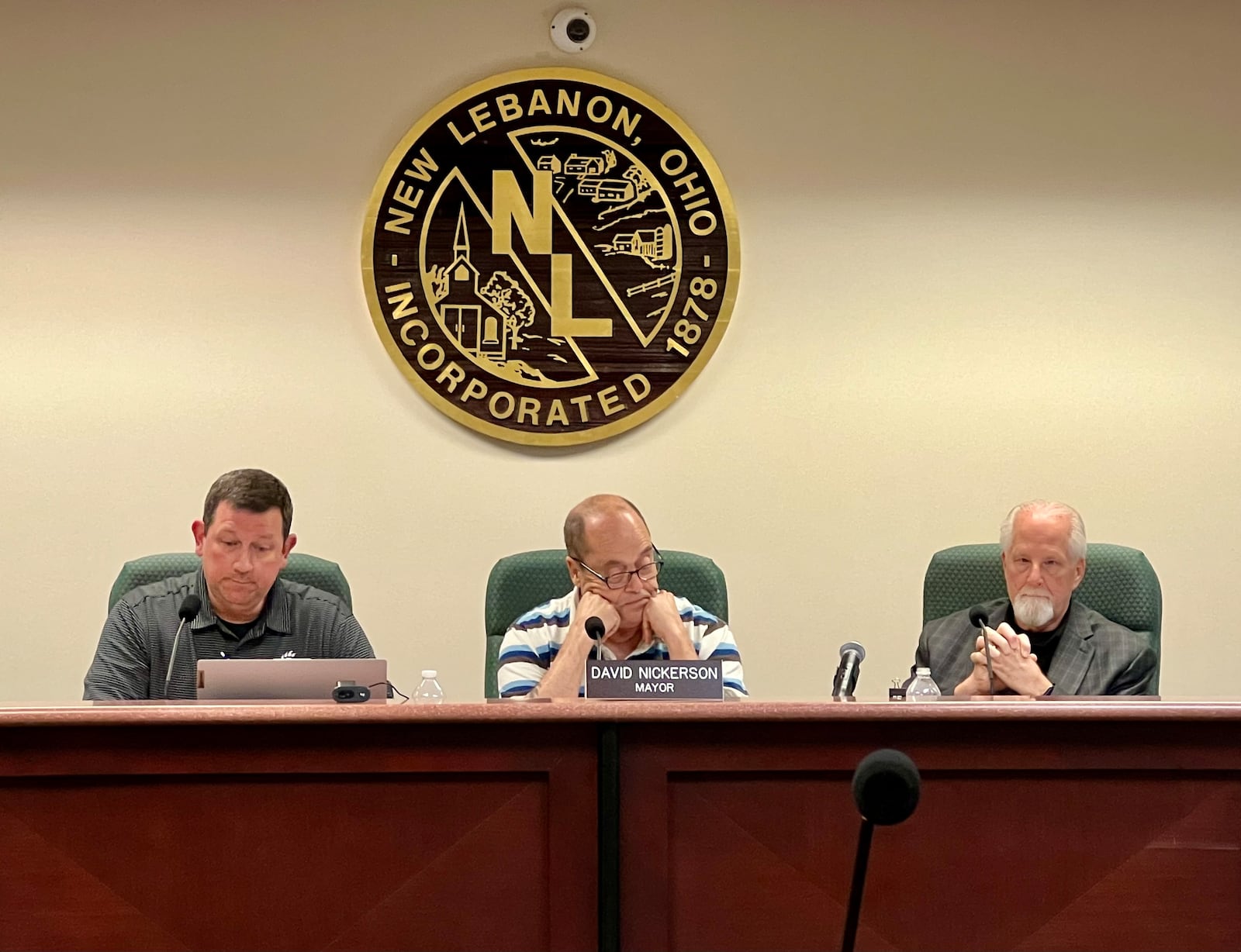 Acting New Lebanon Village Manager Rob Anderson, left, listens to resident comments during a regular meeting on May 7, 2024, along with Mayor David Nickerson, center, and Acting Law Director Michael McNamee. AIMEE HANCOCK/STAFF