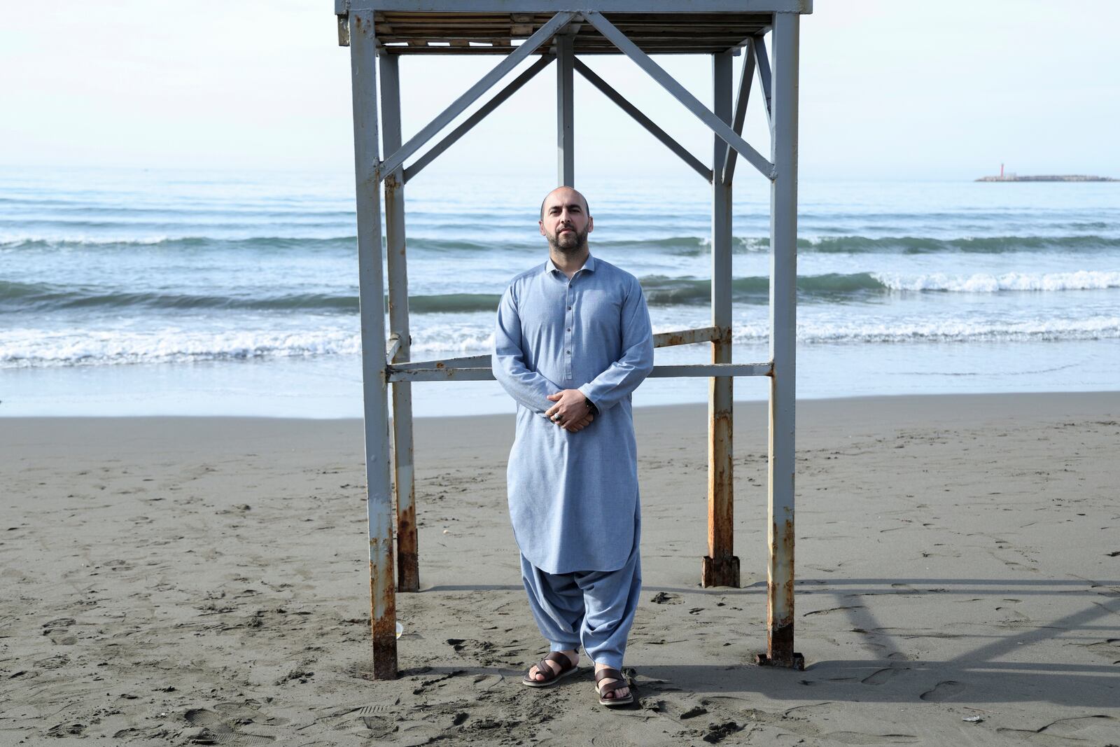 Afghan Mohammad Inbrahim, 35, who had worked with the U.S. Army, poses at a beach in Shengjin, northwestern Albania, Monday, Jan. 27, 2025. (AP Photo/Vlasov Sulaj)