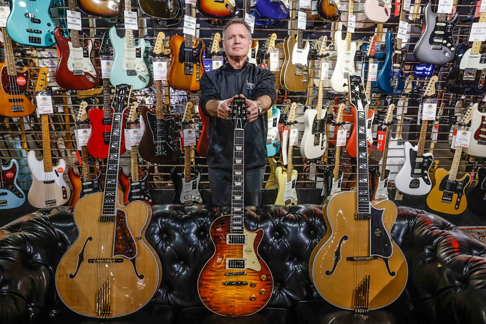 Hauer Music president, Jim Hauer show-off three of his stores most expensive guitars. Many famous and not so famous musicians have walked through the doors. The store is located at 528 Miamisburg-Centerville Road in Centerville. JIM NOELKER/STAFF