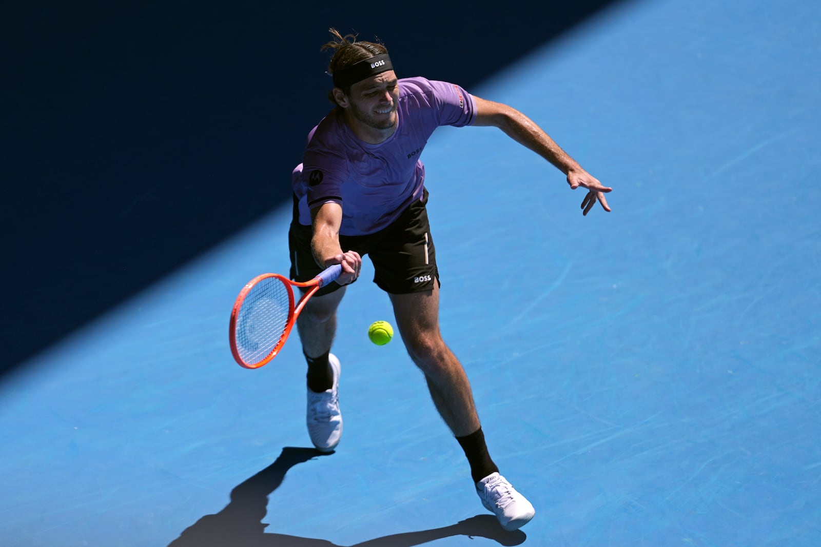 Taylor Fritz of the U.S. plays a forehand return to Cristian Garin of Chile during their second round match at the Australian Open tennis championship in Melbourne, Australia, Thursday, Jan. 16, 2025. (AP Photo/Ng Han Guan)