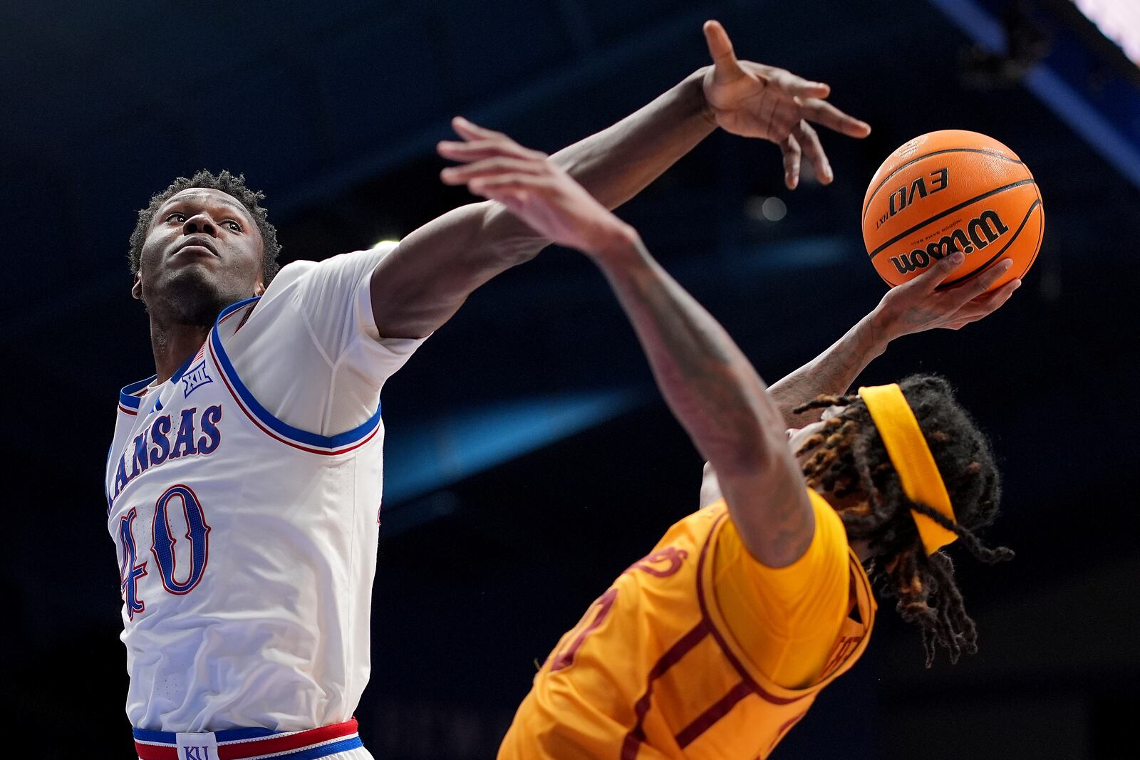 Kansas forward Flory Bidunga (40) attempts to block a shot by Iowa State guard Keshon Gilbert, right, during the second half of an NCAA college basketball game, Monday, Feb. 3, 2025, in Lawrence, Kan. (AP Photo/Charlie Riedel)