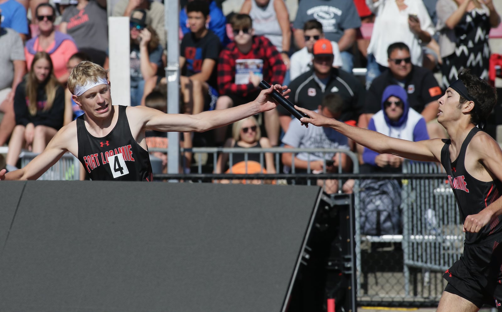 Fort Loramie's Colten Gasson, left, takes the baton from Trey Ranly for the final leg of the 4x800 relay in the Division III state track championship on Friday, June 3, 2022, at Jesse Owens Memorial Stadium in Columbus. Fort Loramie won the event. David Jablonski/Staff