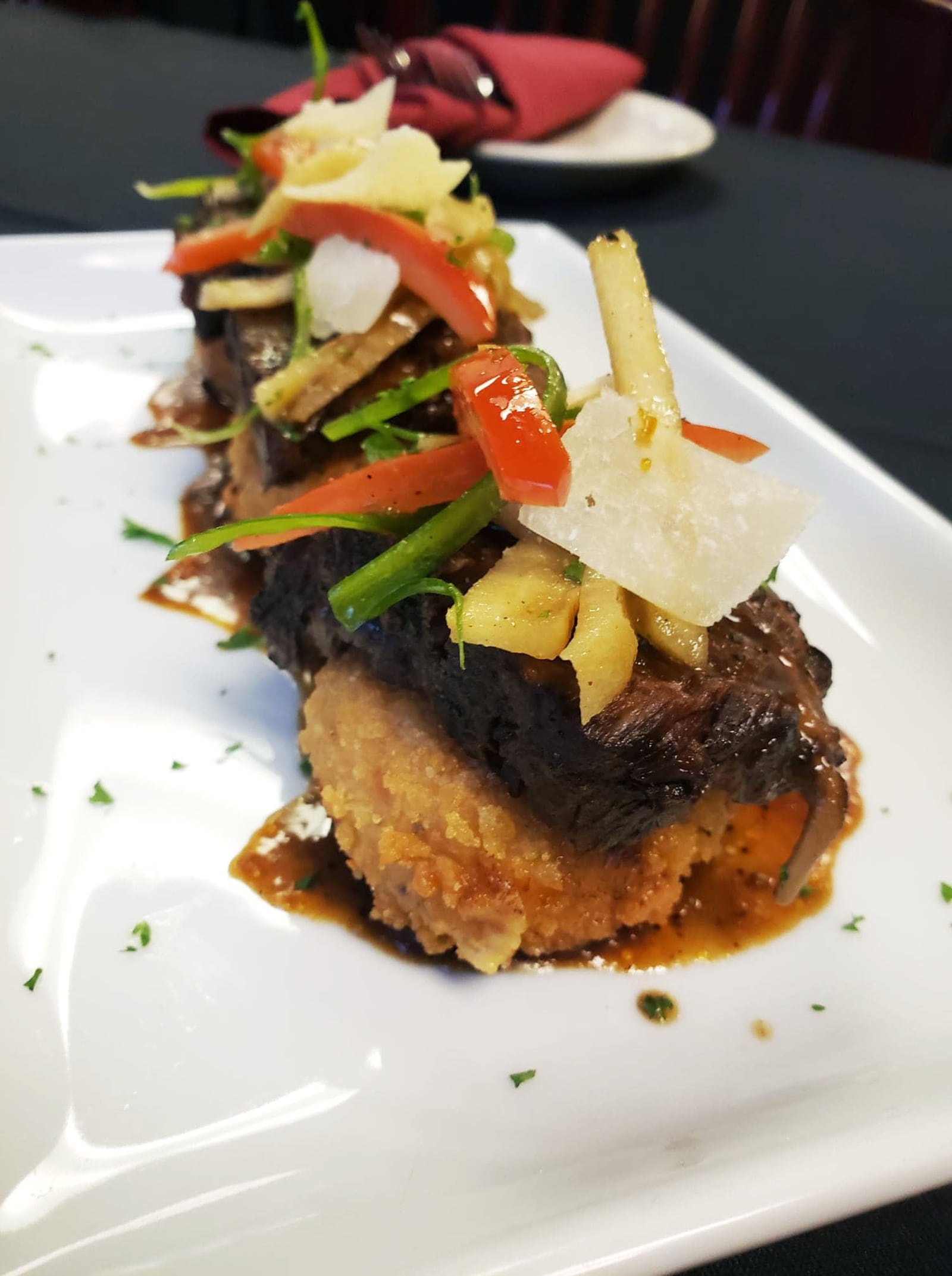 The Smoked and Porter Braised Short Rib is one of the appetizers offered on The Bison & The Boar's new comfort food menu. The short ribs are smoked and slow cooked in porter beer, served over cheddar polenta cakes with charred apple slaw. CONTRIBUTED