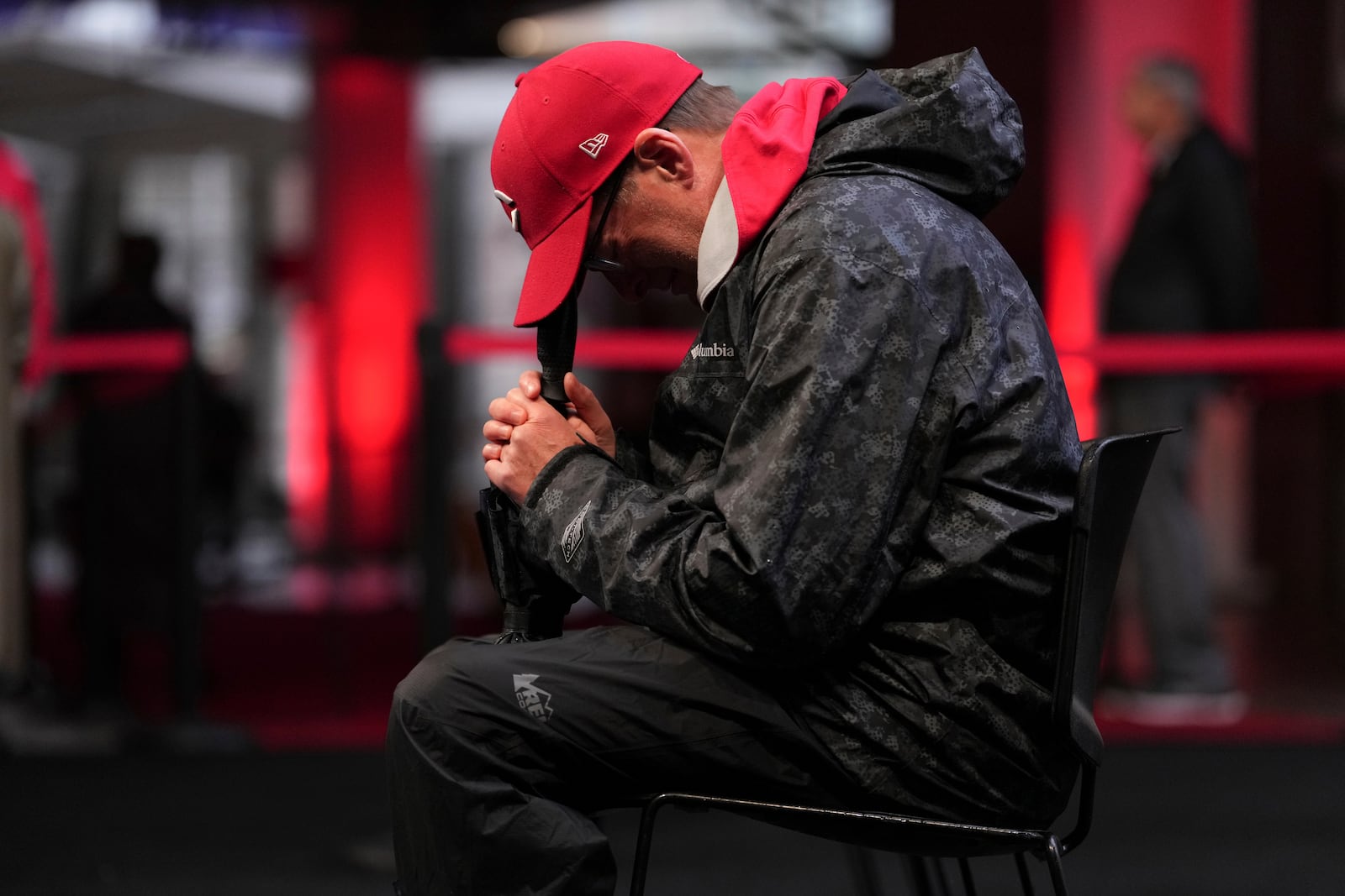 Joe Wilcox, 59, of Lexington, Ky., cries after paying his respects to Cincinnati Reds legend Pete Rose during a public visitation, Sunday, Nov. 10, 2024, at Great American Ball Park in Cincinnati. (AP Photo/Kareem Elgazzar)