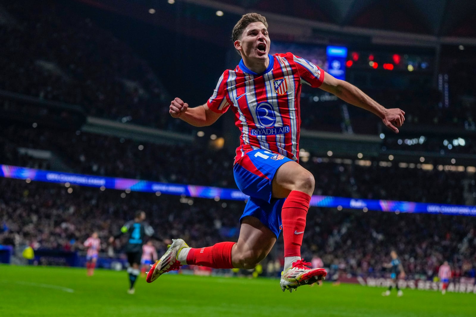 Atletico Madrid's Julian Alvarez celebrates after scoring his side's first goal against Bayer 04 Leverkusen during a Champions League opening phase soccer match at the Riyadh Air Metropolitano stadium in Madrid, Spain, Tuesday, Jan. 21, 2025. (AP Photo/Manu Fernandez)