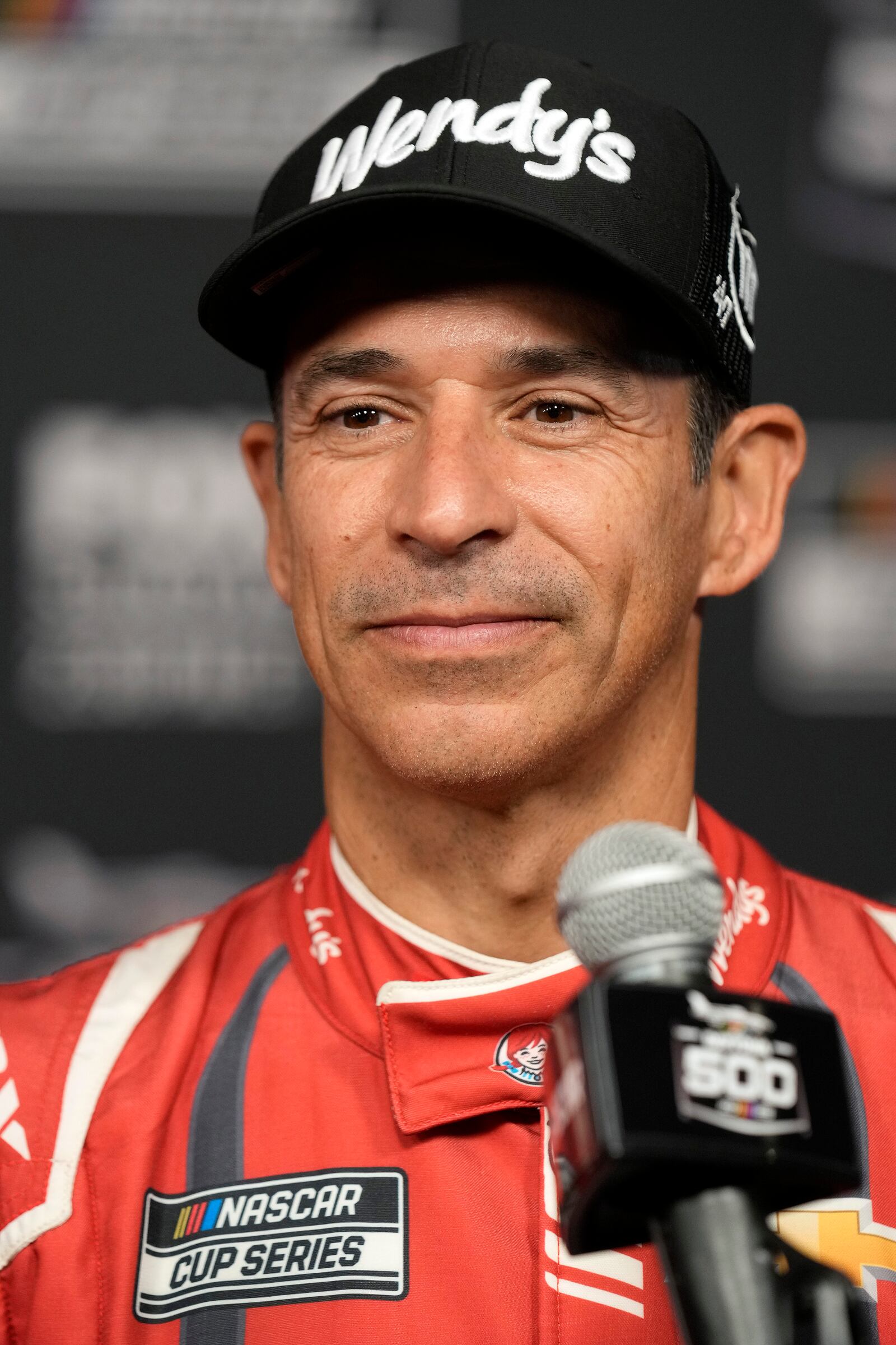 Helio Castroneves, of Brazil, speaks during media day at the NASCAR Daytona 500 auto race, Wednesday, Feb. 12, 2025, at Daytona International Speedway in Daytona Beach, Fla. (AP Photo/John Raoux)