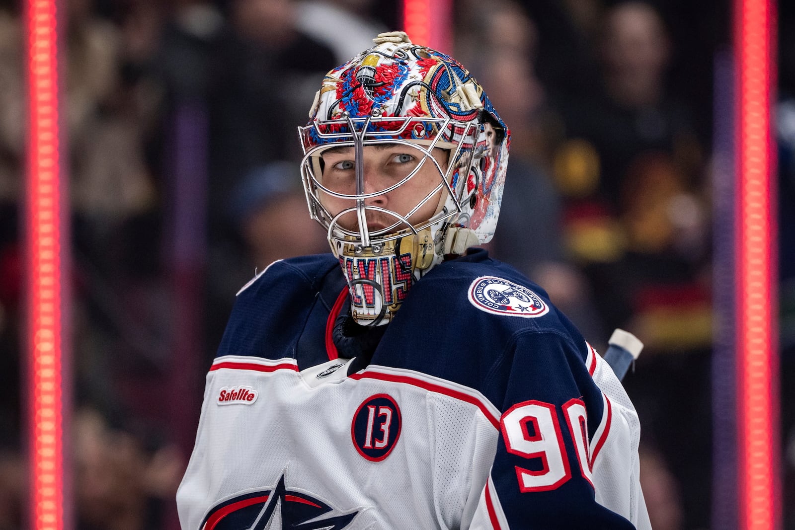 Columbus Blue Jackets goaltender Elvis Merzlikins (90) waits for a face off during the third period of an NHL hockey game against the Vancouver Canucks in Vancouver, British Columbia, Friday, Dec. 6, 2024. (Ethan Cairns/The Canadian Press via AP)