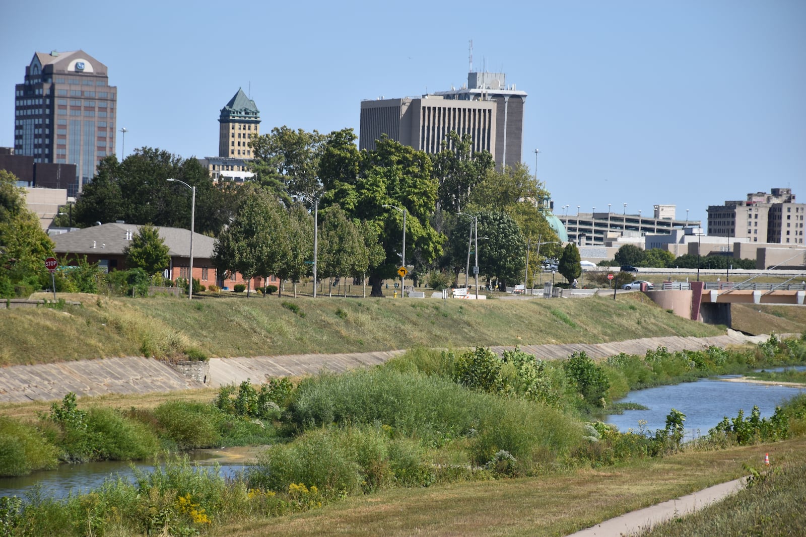 The city of Dayton wants to redesign sections of the flood protection levees on either side of Wolf Creek near the mouth of the tributary to create new ways to access the waterway. CORNELIUS FROLIK / STAFF