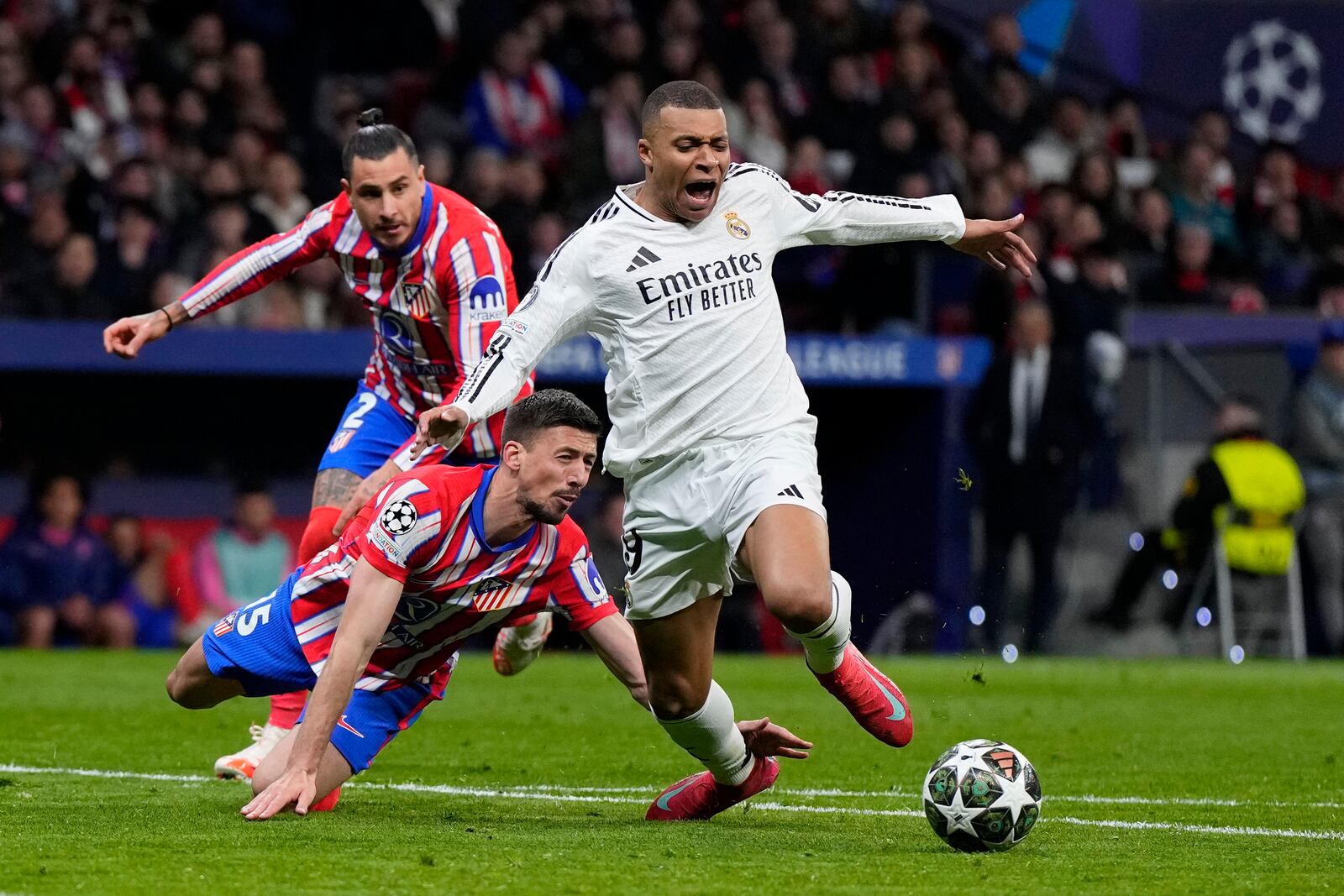 Atletico Madrid's Clement Lenglet, center, fouls Real Madrid's Kylian Mbappe during the Champions League round of 16, second leg, soccer match between Atletico Madrid and Real Madrid at the Metropolitano stadium in Madrid, Spain, Wednesday, March 12, 2025. (AP Photo/Manu Fernandez)