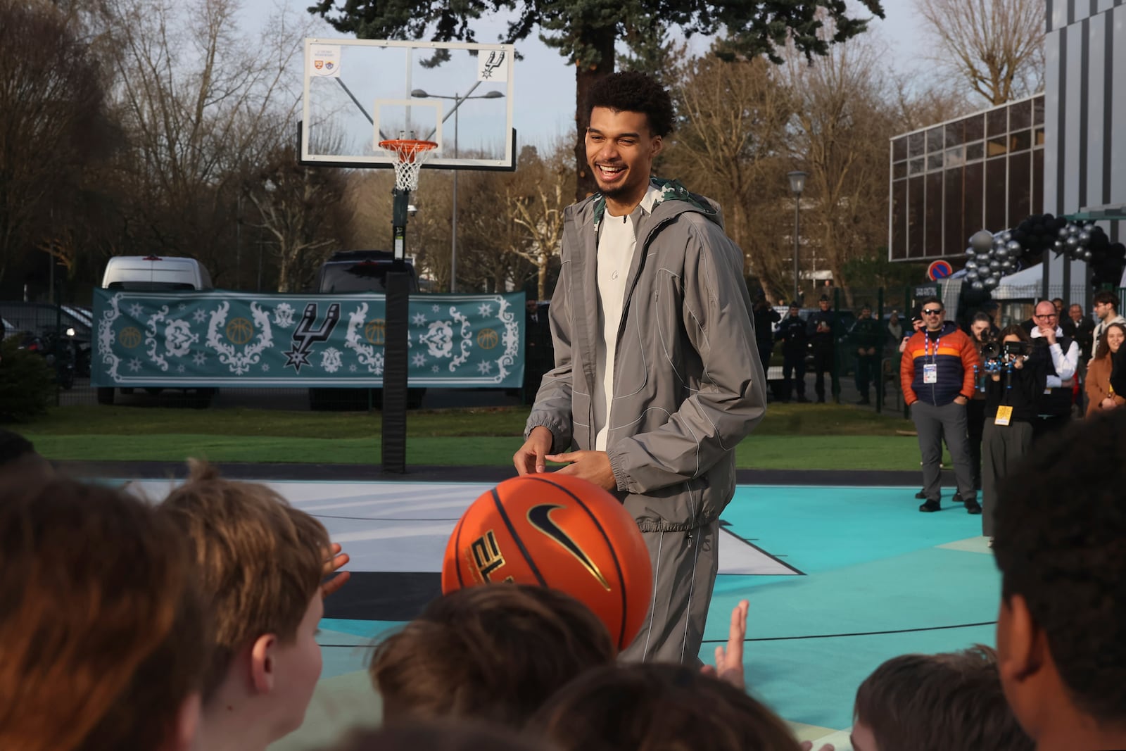 San Antonio Spurs' Victor Wembanyama inaugurates a basketball court, Tuesday, Jan. 21, 2025 in Le Chesnay-Rocquencourt, south of Paris. (AP Photo/Thomas Padilla)