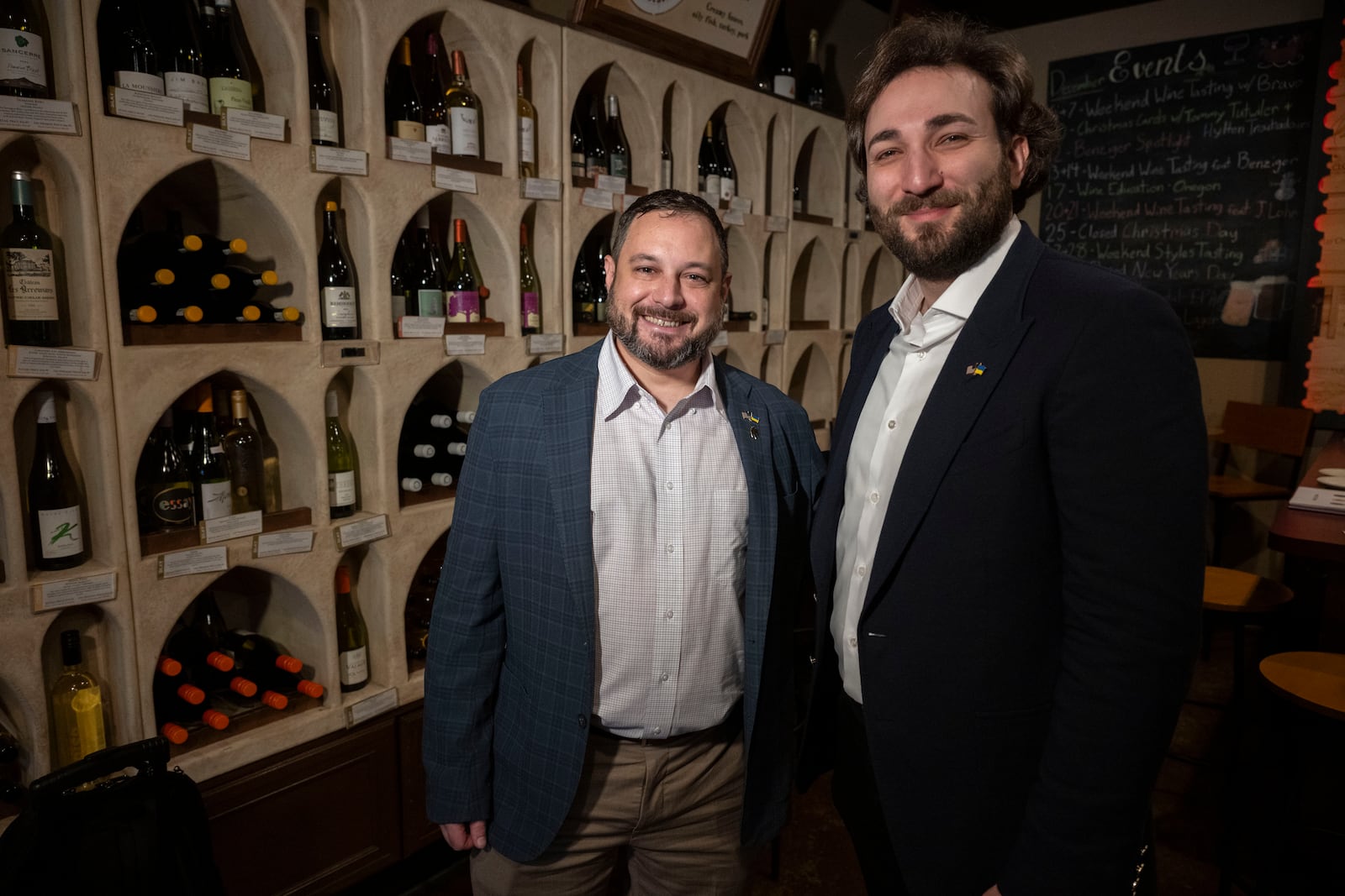 Sam Lerman, CEO of SPYRT Worldwide, and Giorgi Iukuridze, owner and CEO Shabo, a Ukrainian winery, right, stands together for a photo following a wine tasting at Wine Styles, Dec. 20, 2024 in Dumfries, Va. (AP Photo/Kevin Wolf)