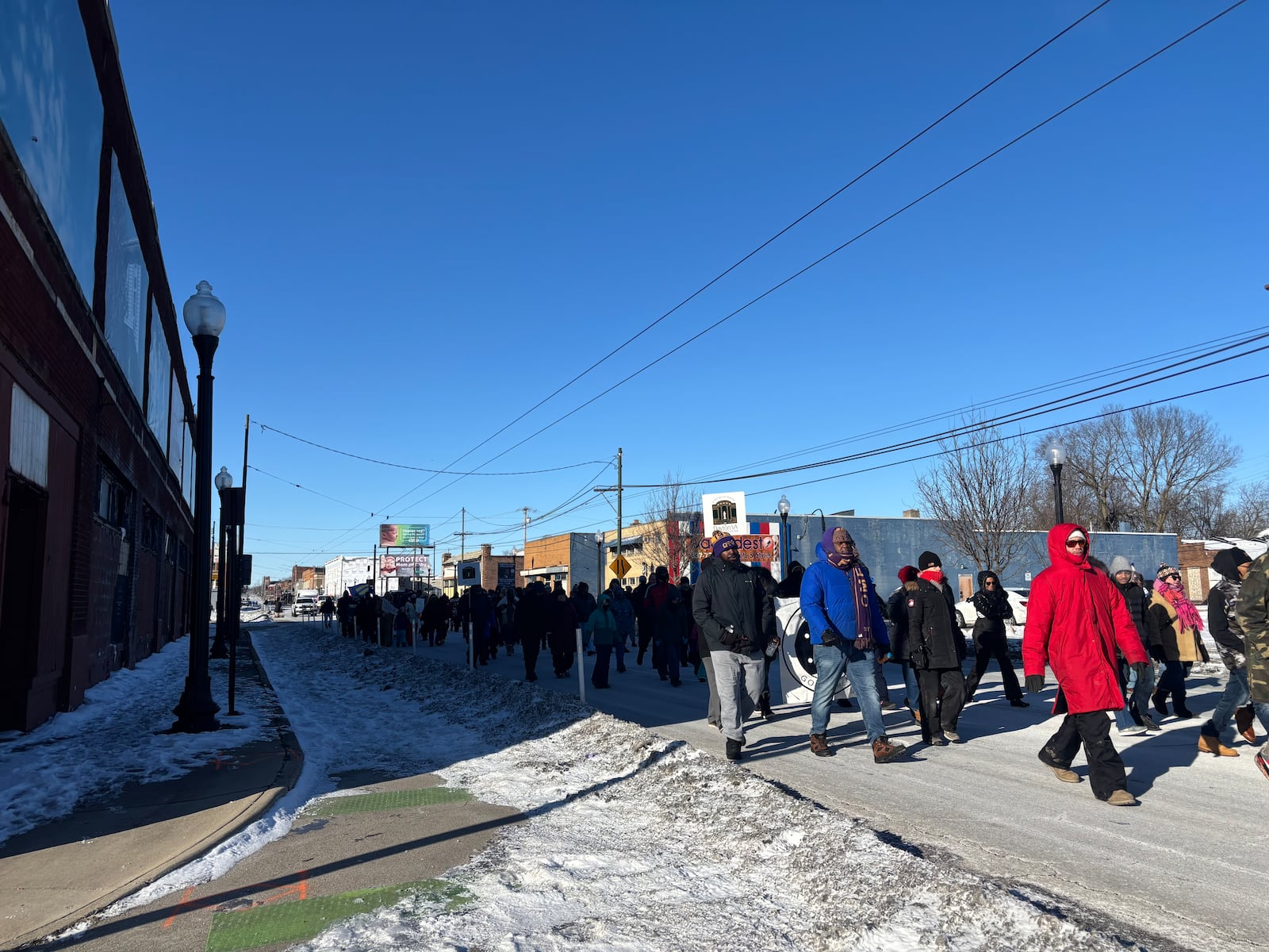 Marchers walk down East Third Street on Monday, Jan. 20 in honor of Martin Luther King, Jr. Eileen McClory / staff