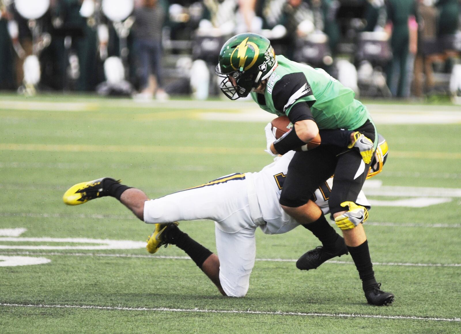 Northmont’s Keaton Kesling (with ball) is taken down by Springfield’s Kedric Holt. Northmont defeated visiting Springfield 25-7 in a Week 7 high school football game on Friday, Oct. 5, 2018. MARC PENDLETON / STAFF