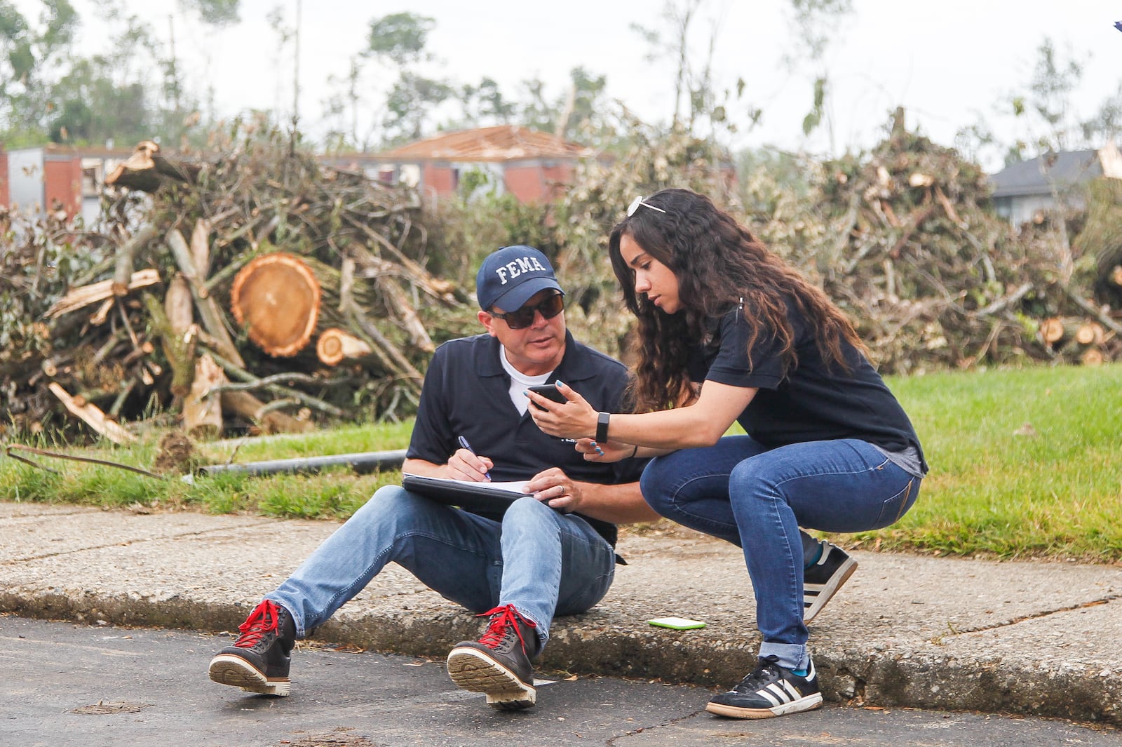 Steve Cooper and Malyssa Suarez, both with the Federal Emergency Management Agency, conduct a joint preliminary assessment of tornado-damage Wednesday at the Westbrooke Village Apartments in Trotwood. CHRIS STEWART / STAFF