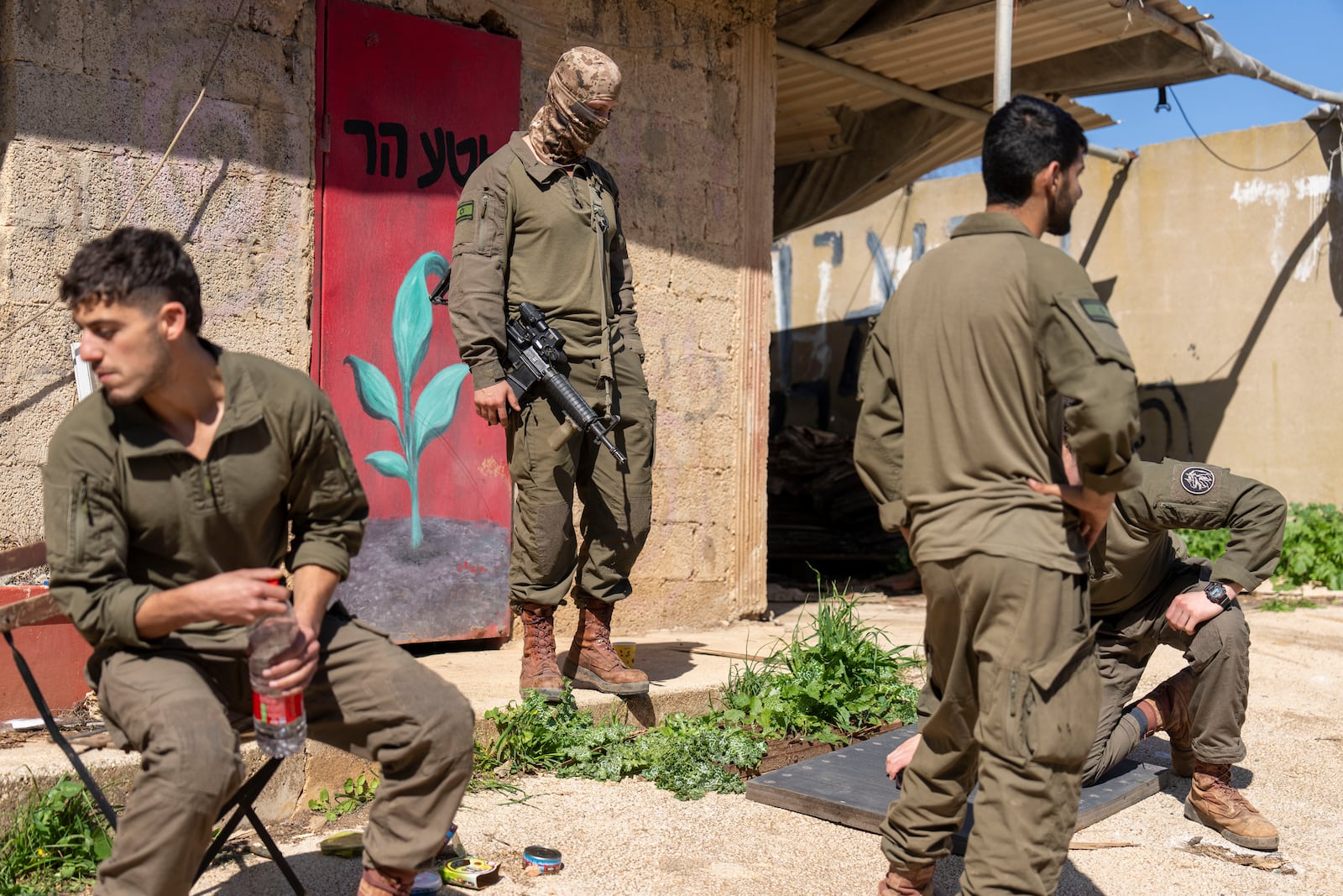 Israeli soldiers gather in northern Israel after Israeli forces withdrew from border villages in southern Lebanon ,Tuesday, Feb. 18, 2025. (AP Photo/Ariel Schalit)