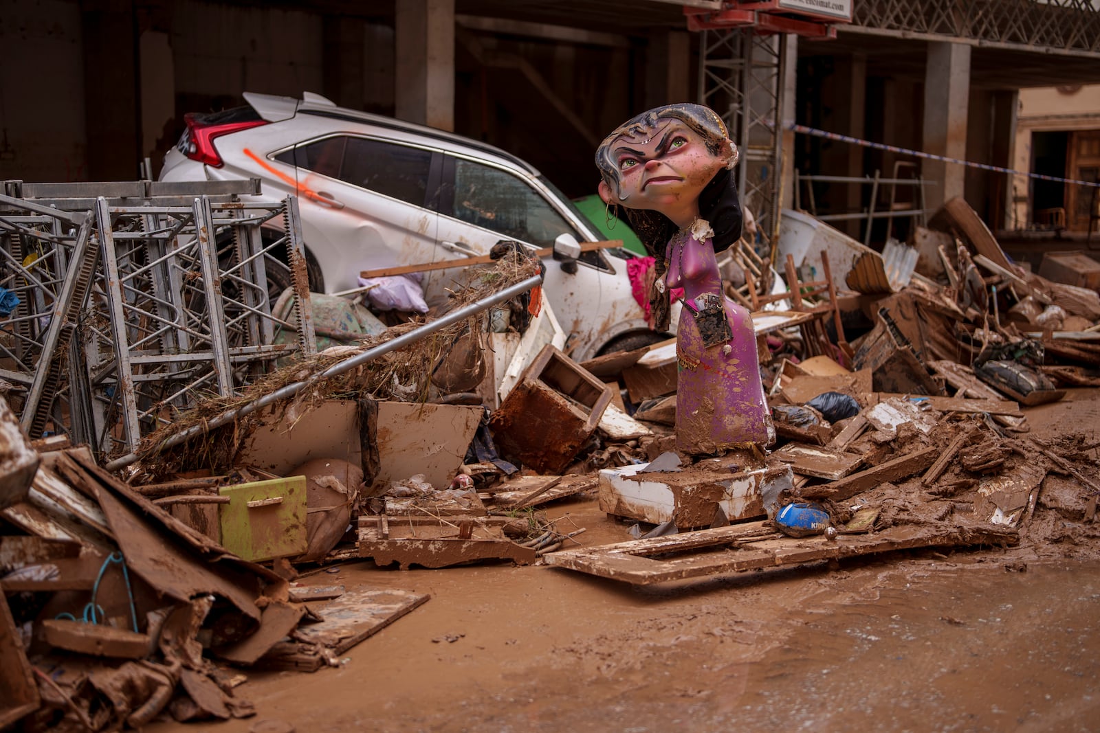 A "Falla" figure structure made of cardboard and other materials is damaged in an area affected by floods in Catarroja, Spain, on Monday, Nov. 4, 2024. (AP Photo/Manu Fernandez)