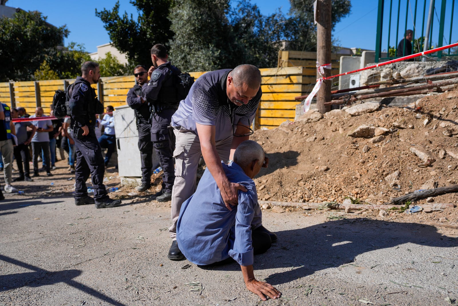 People react at the site where one person was killed after a projectile launched from Lebanon slammed into Maalot-Tarshiha, northern Israel, Tuesday, Oct. 29, 2024. (AP Photo/Ohad Zwigenberg)