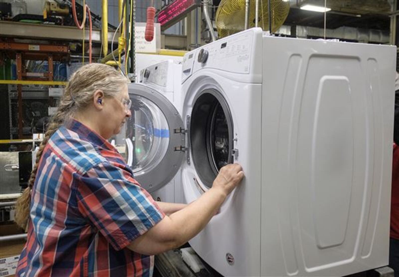 Anna Snyder works on the assembly line building washing machines at Whirlpool in Clyde Ohio. JEREMY WADSWORTH/THE BLADE