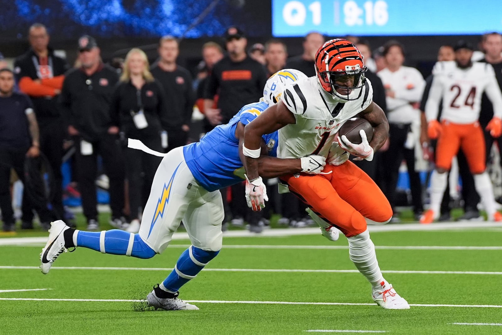 Cincinnati Bengals wide receiver Ja'Marr Chase (1) is tackled by Los Angeles Chargers linebacker Denzel Perryman (6) during the first half of an NFL football game Sunday, Nov. 17, 2024, in Inglewood, Calif. (AP Photo/Gregory Bull)