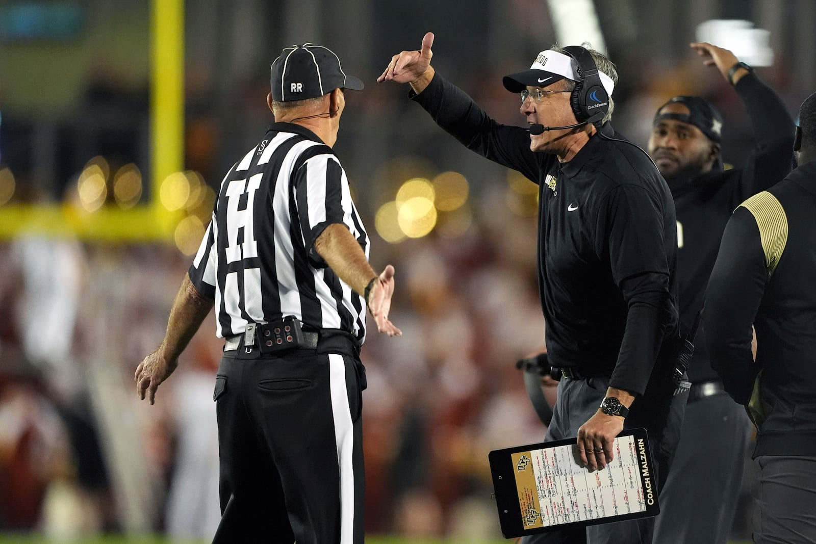 Central Florida head coach Gus Malzahn disputes a pass interference call with an official during the second half of an NCAA college football game against Iowa State, Saturday, Oct. 19, 2024, in Ames, Iowa. (AP Photo/Matthew Putney)