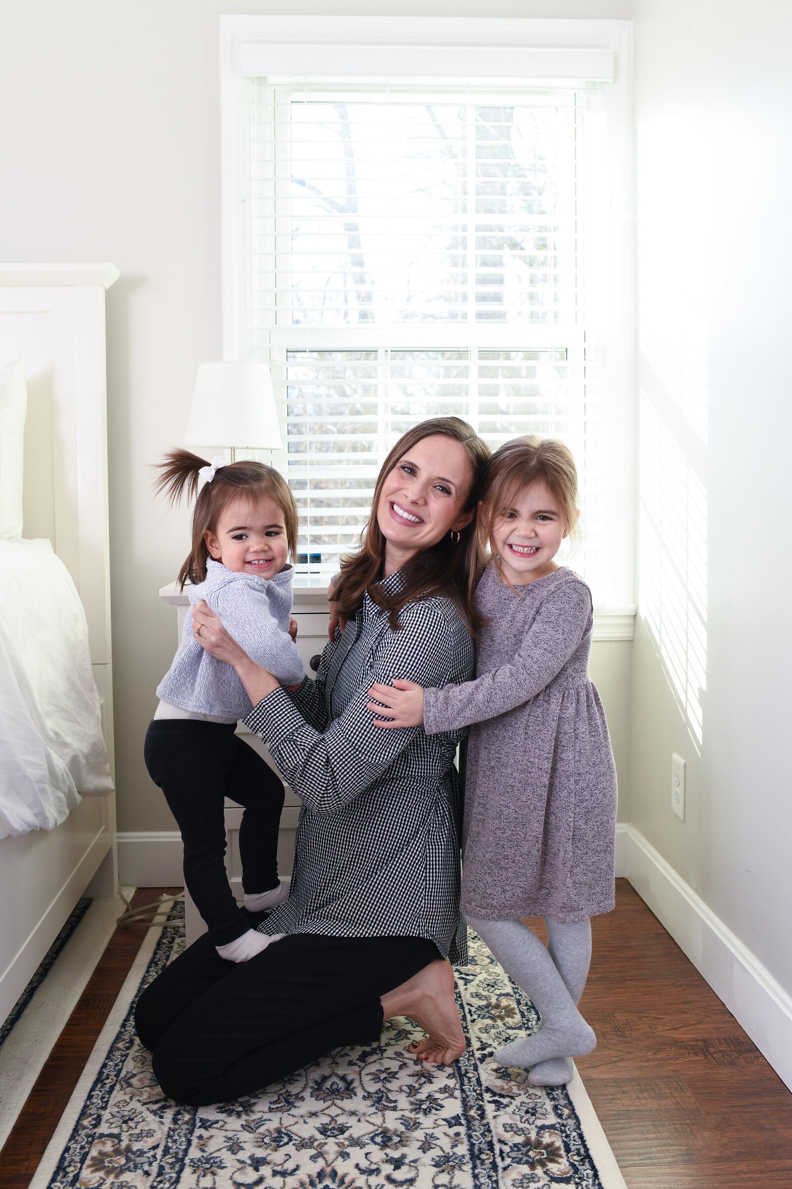 Kallile is grateful to be able to be home with her daughters, Annie, 18 months, (left) and Lucy, 4 (right) as she launches a new business venture, Lunnie. She is expecting her third daughter next month.  