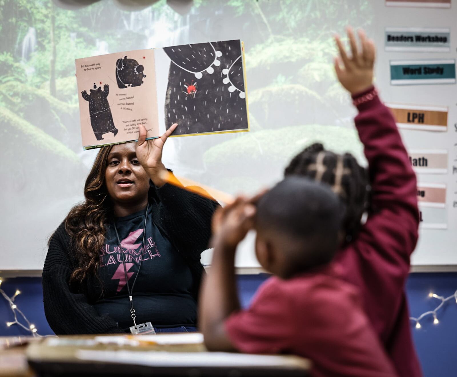 Dayton Leadership Academies first grade teacher Tahirah Smith reads to the children Friday December 1, 2023. A rising number of students are now enrolled in charter and private schools in Ohio. JIM NOELKER/STAFF