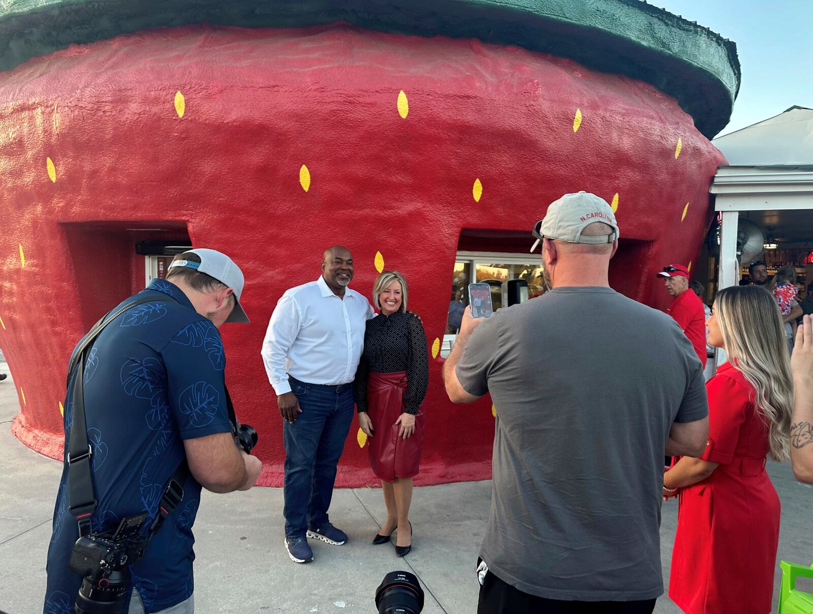 North Carolina Republican gubernatorial nominee and Lt. Gov. Mark Robinson poses for a picture with a supporter outside The Berry Patch ice cream stand in Ellerbe, N.C., Wednesday, Oct. 30. 2024. (AP Photo/Gary D. Robertson)