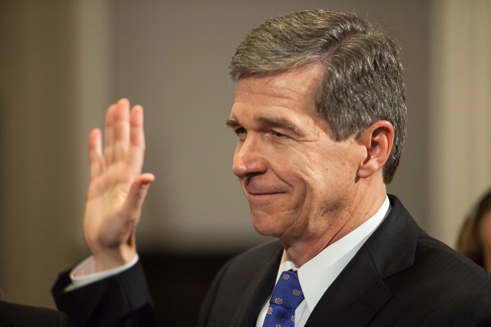 FILE - Roy Cooper is sworn in as North Carolina governor shortly after midnight at the historic state Capitol Building in Raleigh, N.C., early Sunday, Jan. 1, 2017. (AP Photo/Ben McKeown, Pool, File)