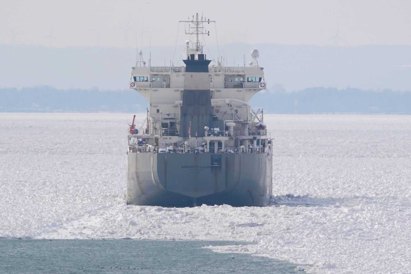 The lake freighter Manitoulin is immobilized by thick ice in Lake Erie outside the Buffalo River breakwall as it awaits the arrival of U.S. Coast Guard Cutter Bristol Bay which is en route from Erie, Penn. to help loosen the vessel, Thursday, Jan. 23, 2025. (Derek Gee/The Buffalo News via AP)