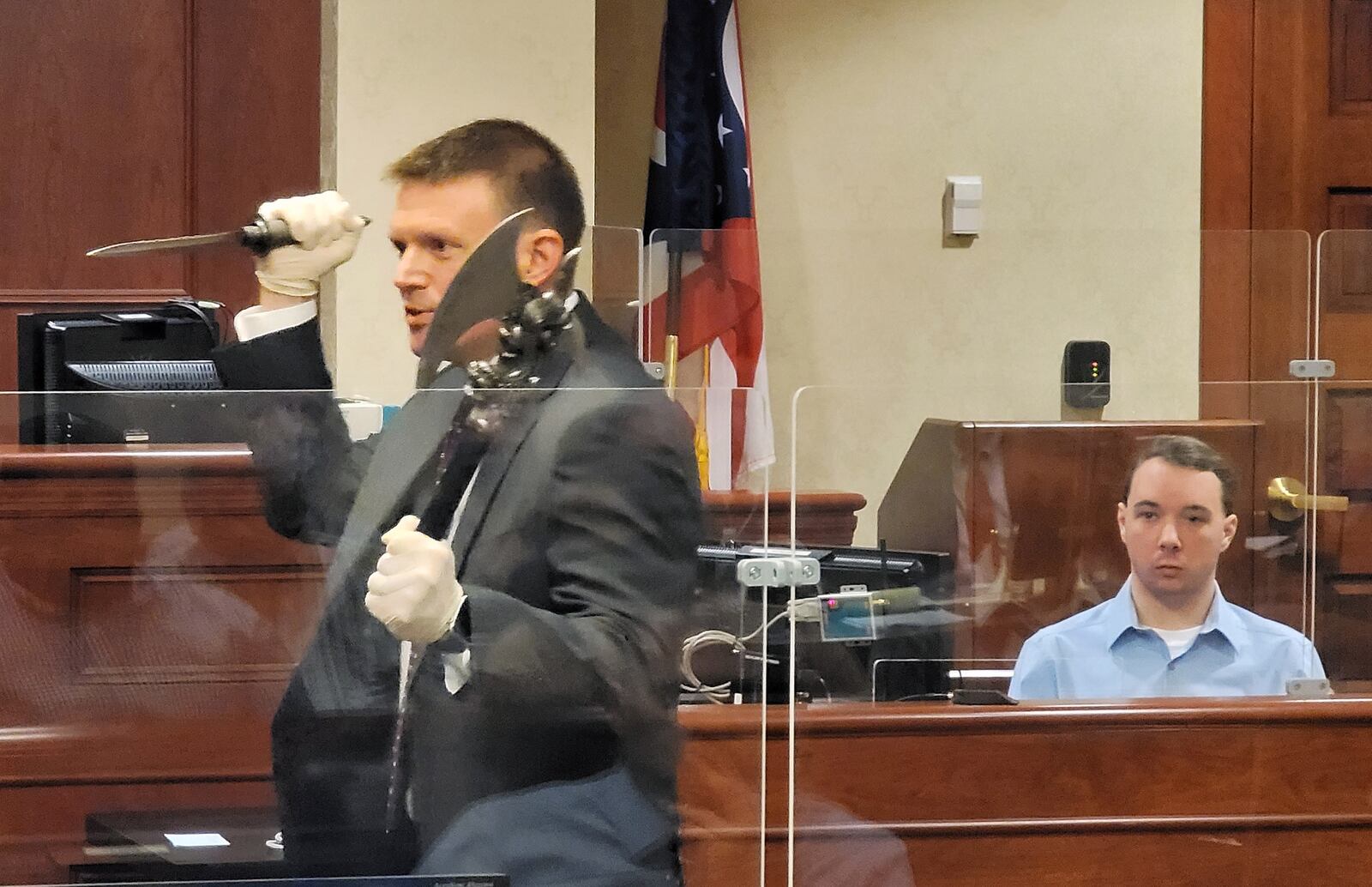 Assistant prosecutor Jon Marshall shows weapons as evidence as he cross examines Peyton McFarland during his trial for the death of Chris Hacker Friday, April 23, 2021 in Butler County Common Pleas Court in Hamilton. NICK GRAHAM / STAFF