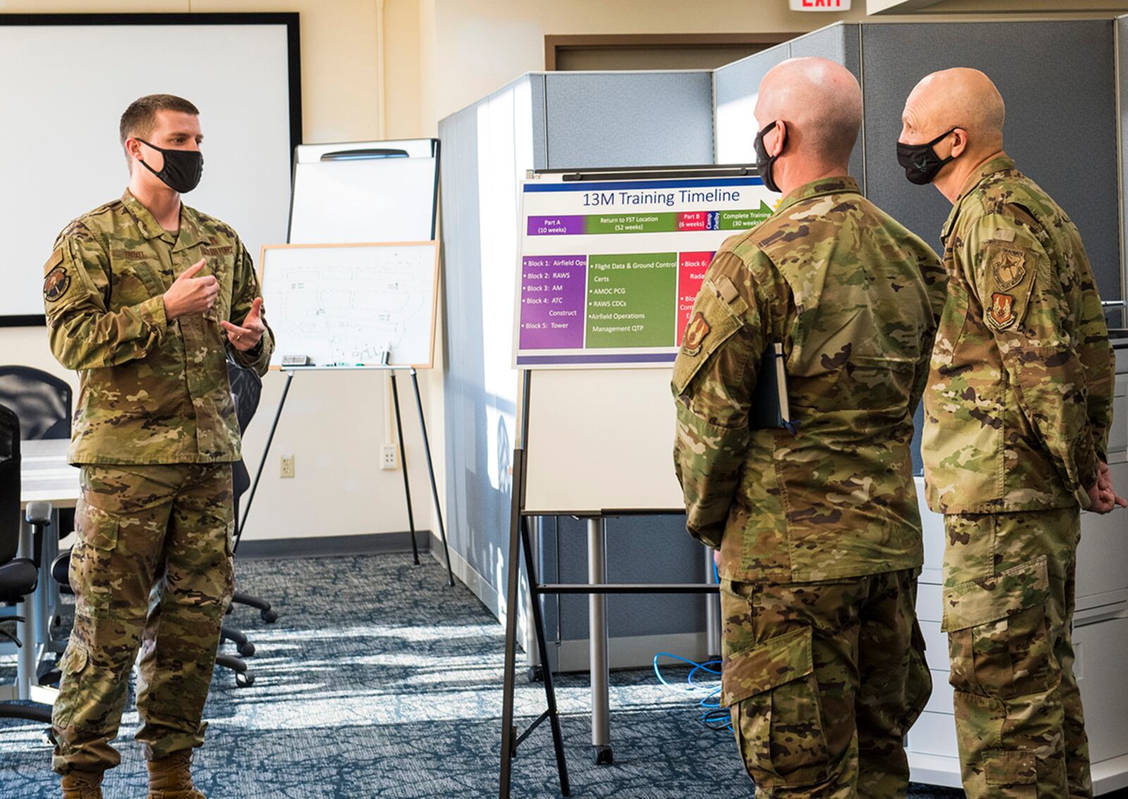 Gen. Arnold W. Bunch Jr. (right), Air Force Materiel Command commander, and Chief Master Sgt. David Flosi (center), AFMC command chief, receive a brief from Maj. Hollis Troxel, 88th Operations Support Squadron director of operations, during a visit to the 88th Air Base Wing at Wright-Patterson Air Force Base on Jan. 21. U.S. AIR FORCE PHOTO/JAIMA FOGG