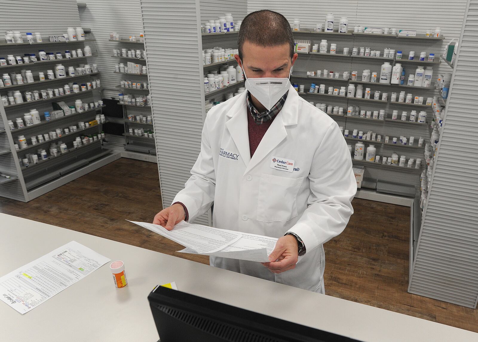 Thad Franz, Director of Pharmacy Services, Cedar Care Village Pharmacy, prepares a prescription Friday. MARSHALL GORBY\STAFF