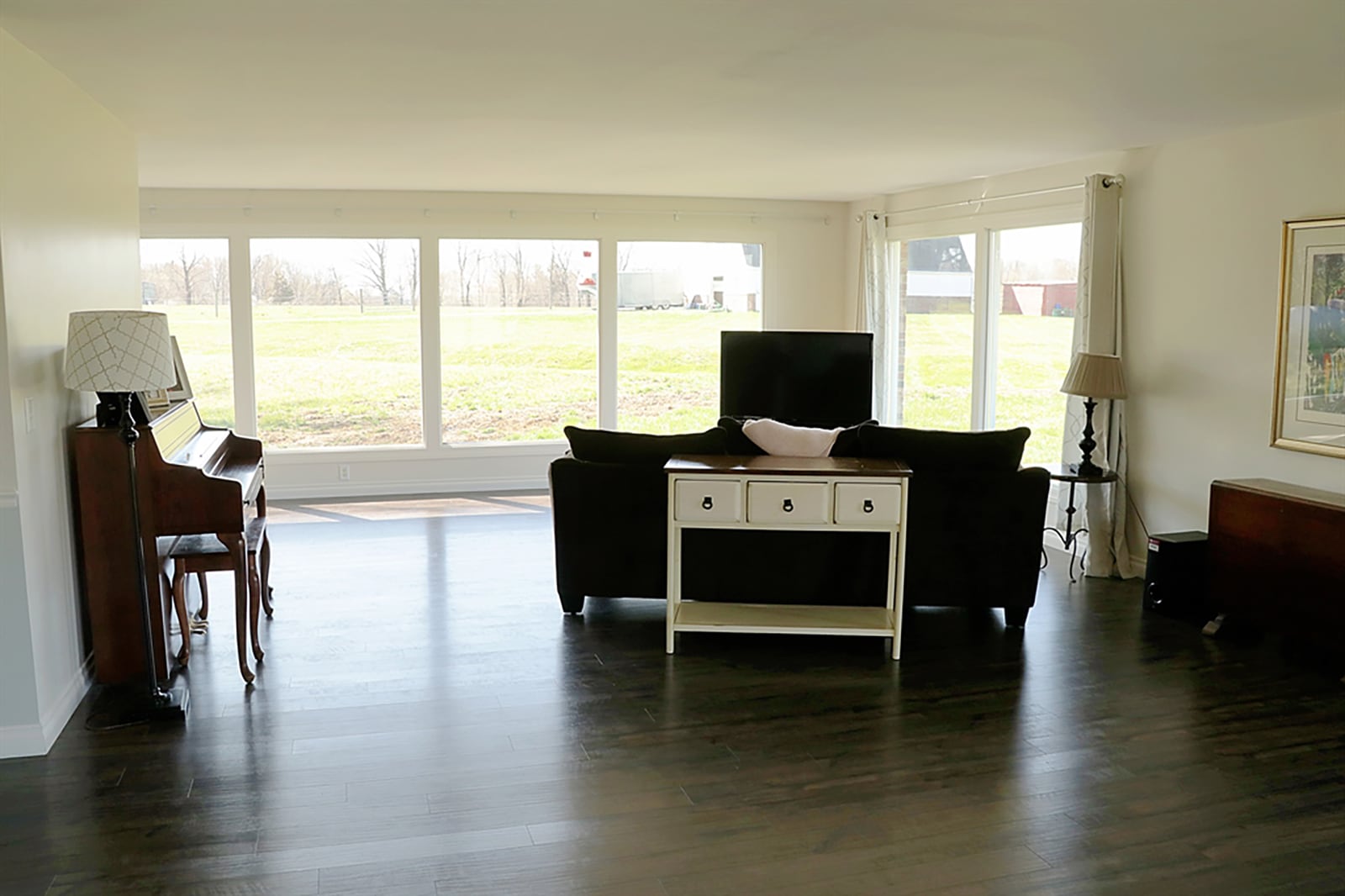 Picture windows fill the great room with natural light and views of the 20-acre equestrian farm. Wood flooring was installed in 2019 throughout the main social areas and the bedrooms. CONTRIBUTED PHOTO BY KATHY TYLER