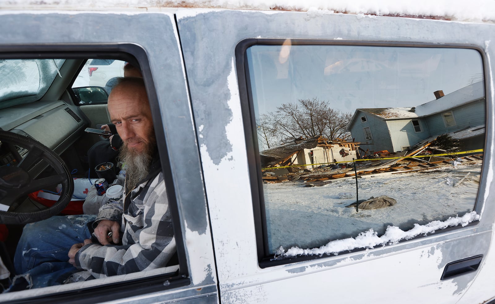 Phillip Kraft sits in his vehicle staying warm looking at is apartment building at 59 Parnell Ave. that exploded early Tuesday morning Feb. 18, 2024. What caused the explosion is
under investigation. MARSHALL GORBY\STAFF