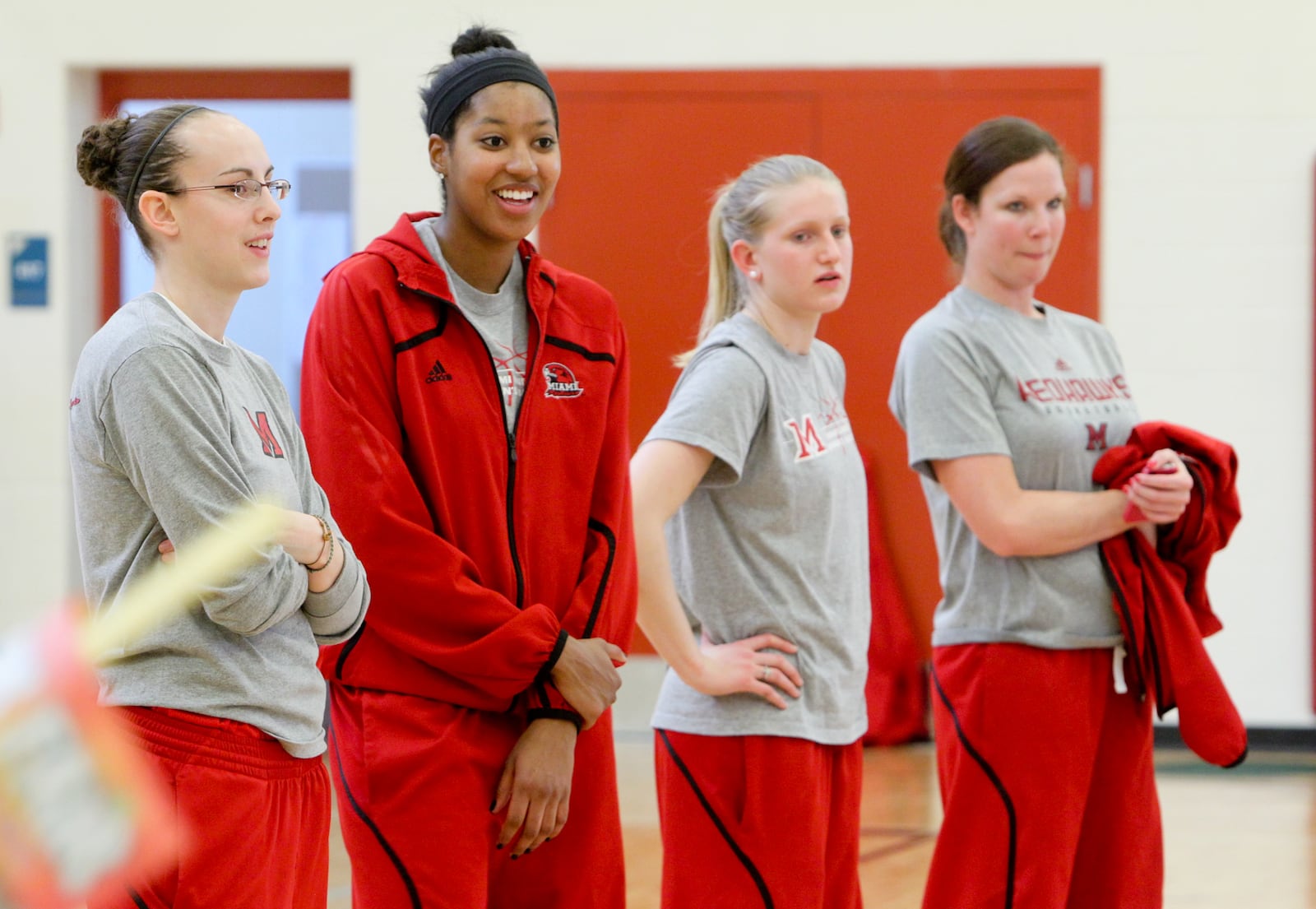 Miami University women's basketball players (from left) Maggie Boyle, Kelsey Simon, Courtney Larson and assistant coach Colleen Day at Crawford Woods elementary in Hamilton. Staff file photo by Greg Lynch